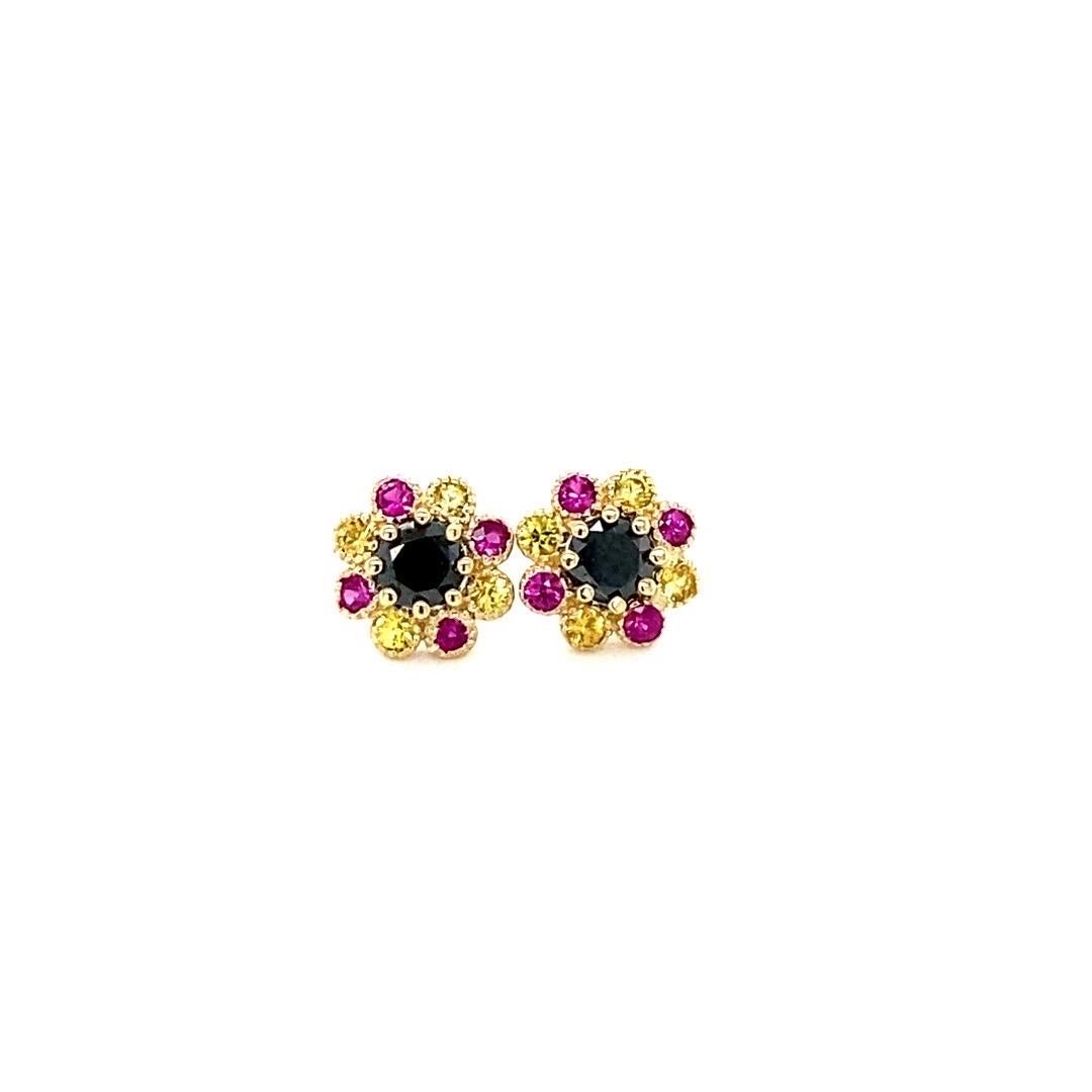 Cute, dainty earrings that are versatile and great for an everyday look! 
1.41 Carat Black Diamond Pink and Yellow Sapphire Yellow Gold Stud Earrings

There are 2 Black Diamonds in the center that weigh 0.76 carats and 16 Pink and Yellow Sapphires