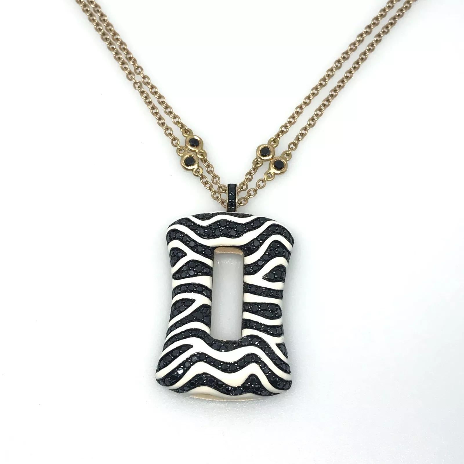 Zebra Print Black Diamond and White Enamel Pendant Necklace in 18k Rose Gold

Zebra Print Pendant Necklace features Rows of Pave set Black Diamonds mixed with White Enamel Stripes in an Open Rectangular Pendant in 18k Rose Gold on an 18k Rose Gold