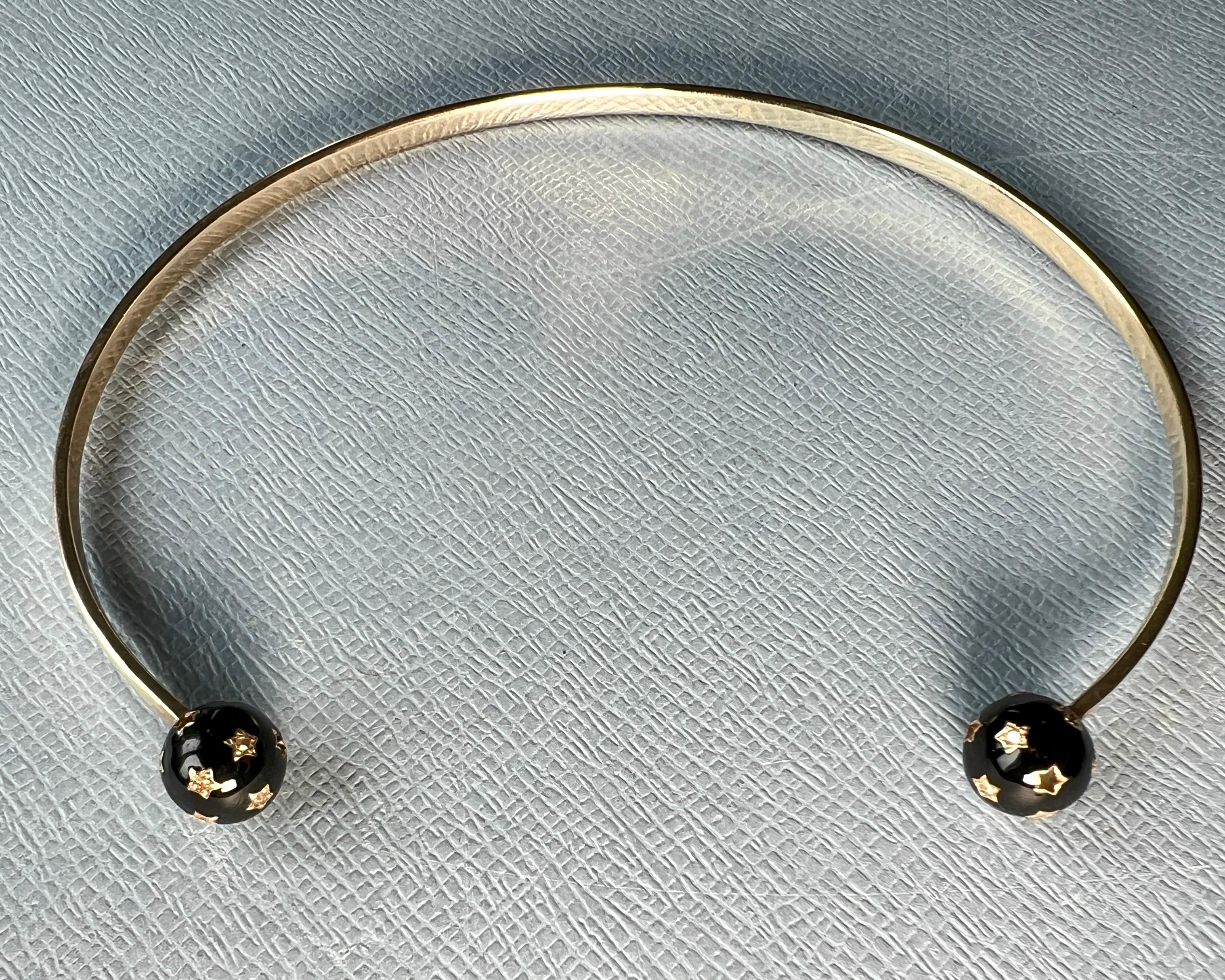 Black and White Diamond Orb Collar Necklace, Neck Bangle Choker with Enamell Ends


This symbolic neck bangle by J Dauphin features two sculptural star spheres at the front opening, each covered in hand-enameled black stars and set with black and