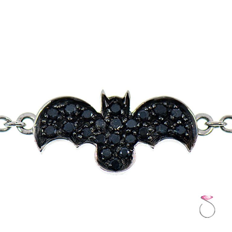 Cute bracelet by Assor Gioielli. This bracelet features a bat charm micro pave' set with black round diamonds attached to a link chain bracelet. The charm is connected on both ends to the chain. A total of 22 round  black diamonds are set on the