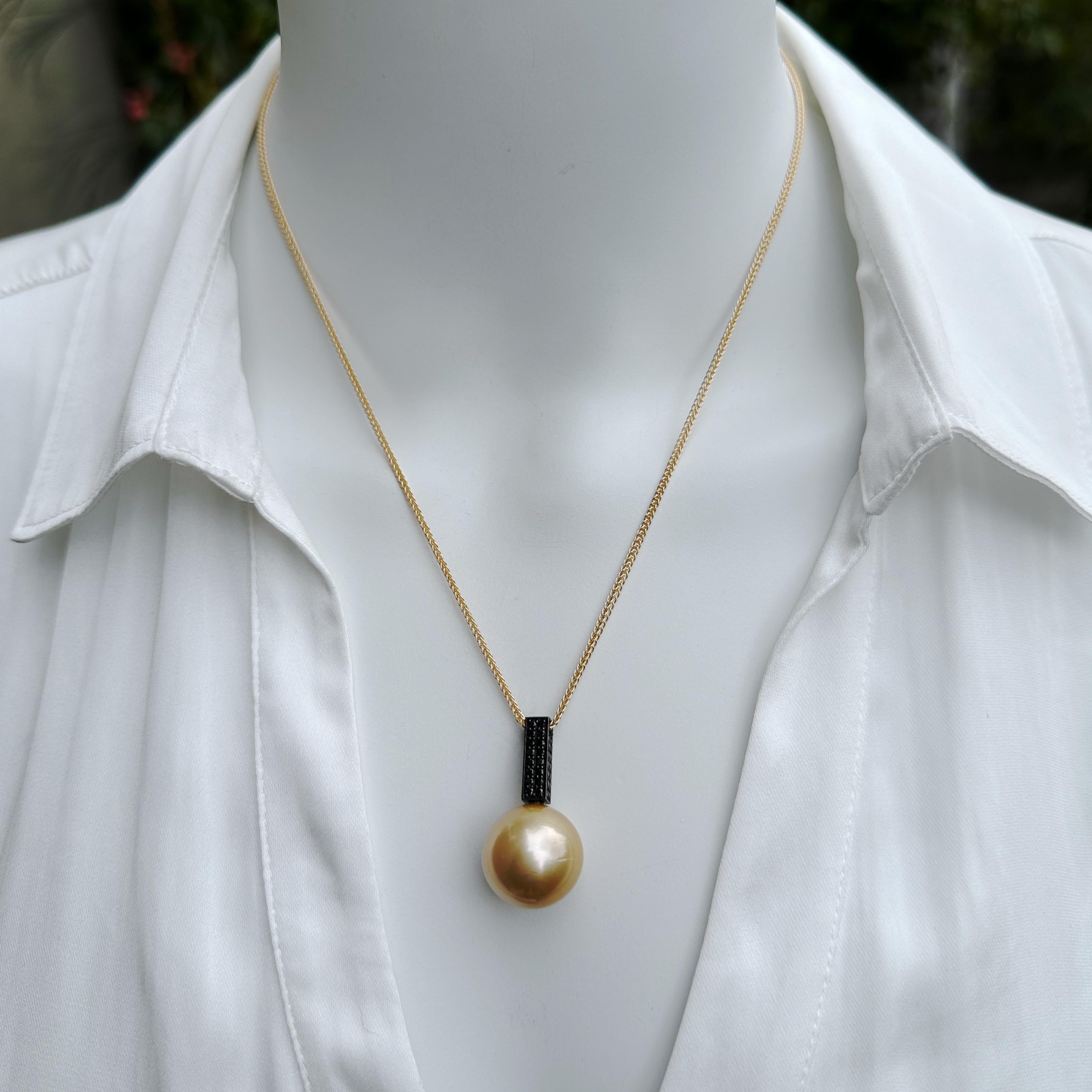 Combining a great new bale design by Eytan Brandes with a great big golden South Sea pearl, this knockout pendant is modern, unique (literally, there's only one), and immediately eye-catching.

The bale is a 14K white gold box that's been dipped in
