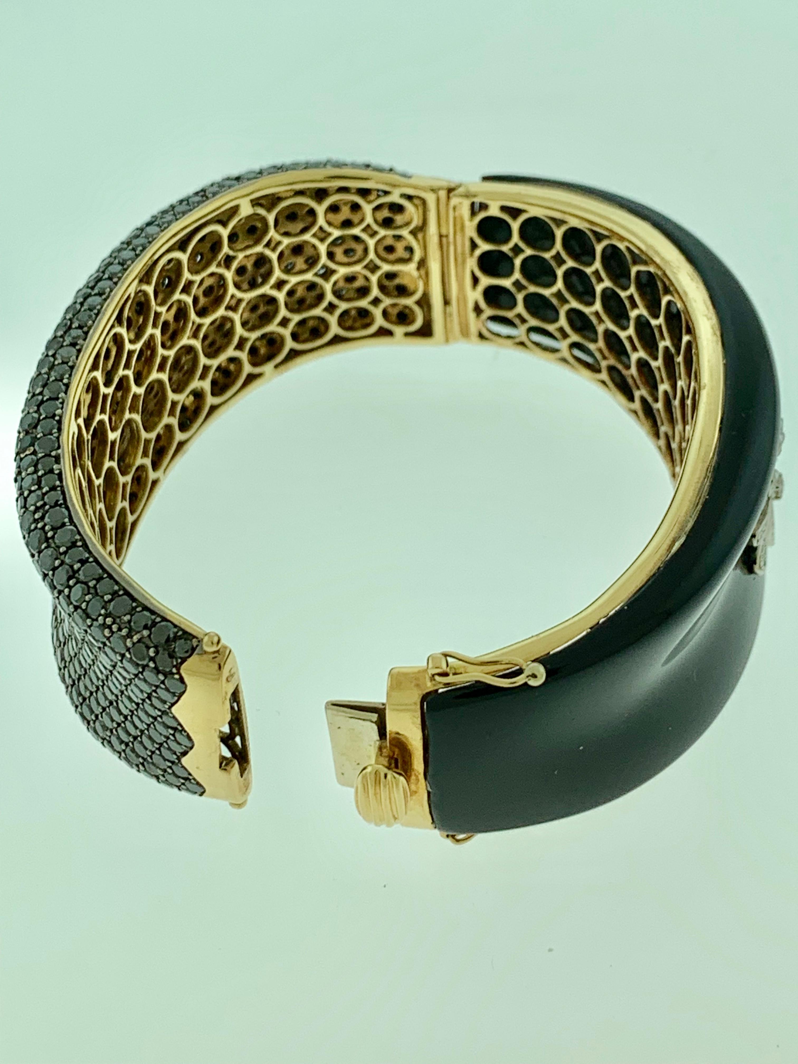Black Diamond & Black Onyx & Diamond  Bangle In 18 Karat Yellow Gold 88 Grams
Weight of the bangle in 18k Yellow  gold  :  88 Grams
It features a bangle style  Bracelet crafted from an 18k Yellow gold and embedded one side with approximately 30 ct