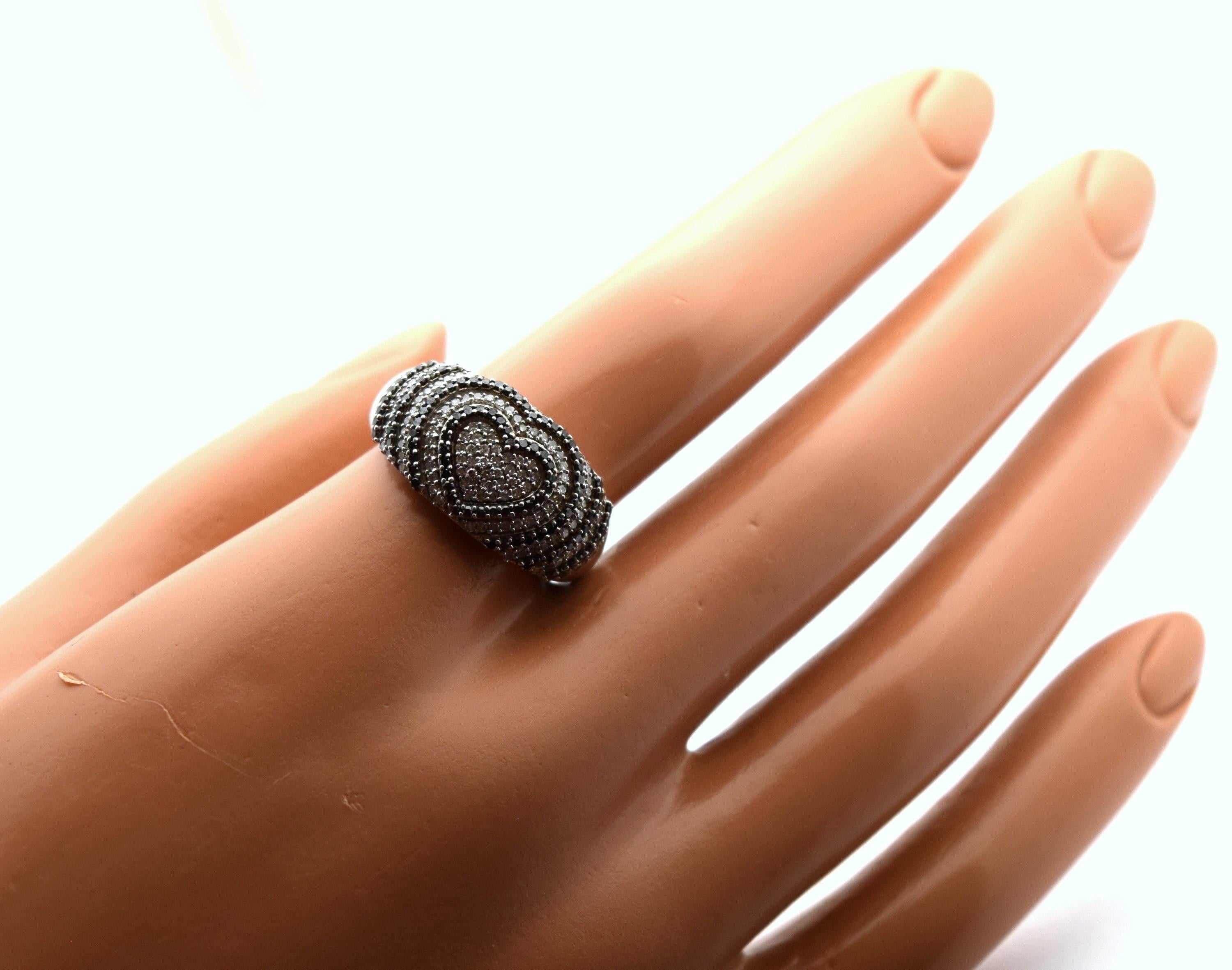 Valentines cocktail ring that will go with any outfit, black diamonds and white diamonds in a beautiful heart design in 14KT white gold. Diamonds totaling 2 carats, size of the ring is 8 can be re-sized.

These will come with a beautiful packaging