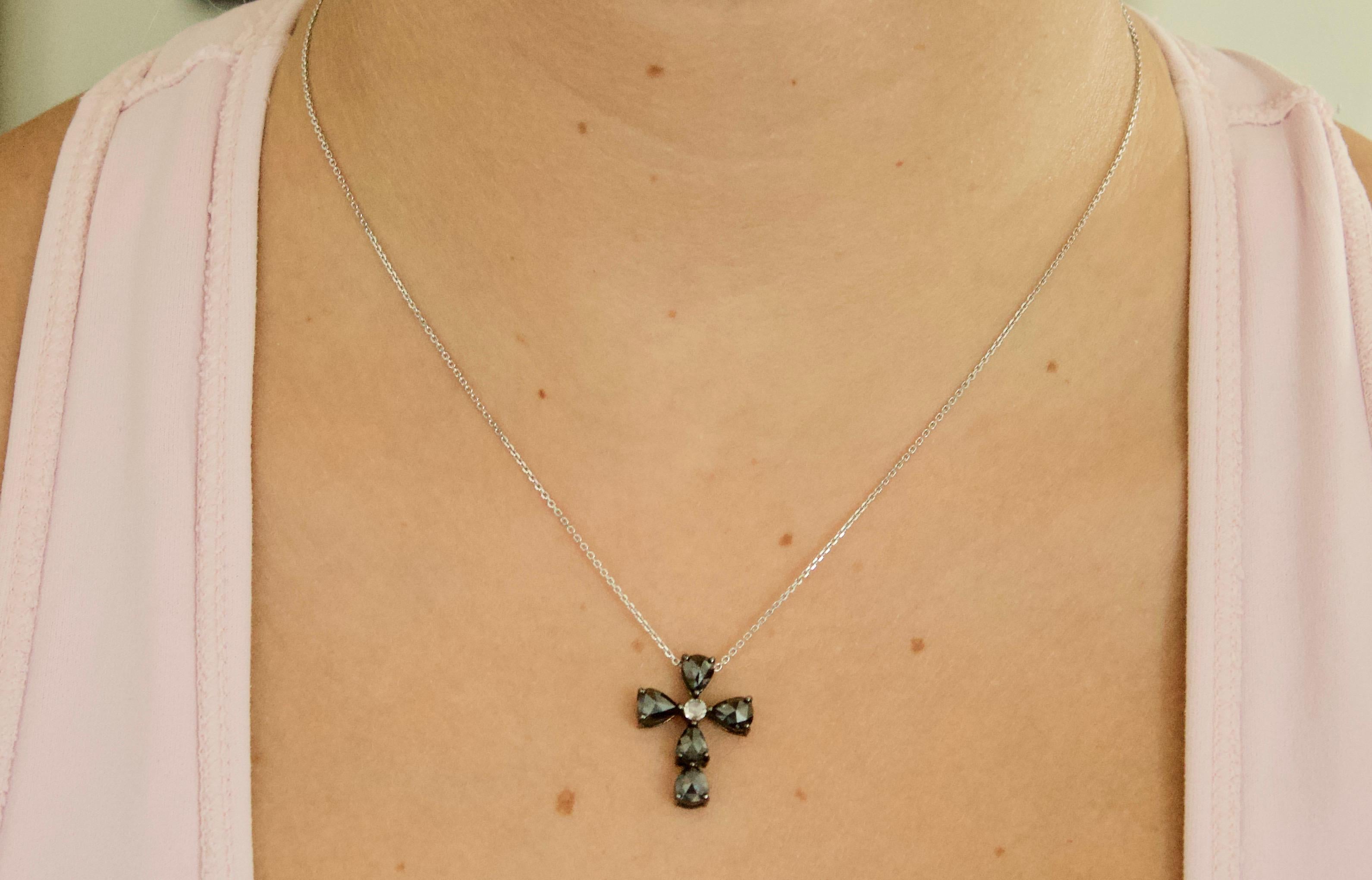 Black Diamond Cross in 18k Oxidized White Gold 1.93 cts.  
Dangles From a 22 inch Adjustable Chain (a slide allows the chain to be shortened for infinite looks)
Six Pear Shaped Black Diamonds Centered with One Round Rose Cut Diamond
Designed