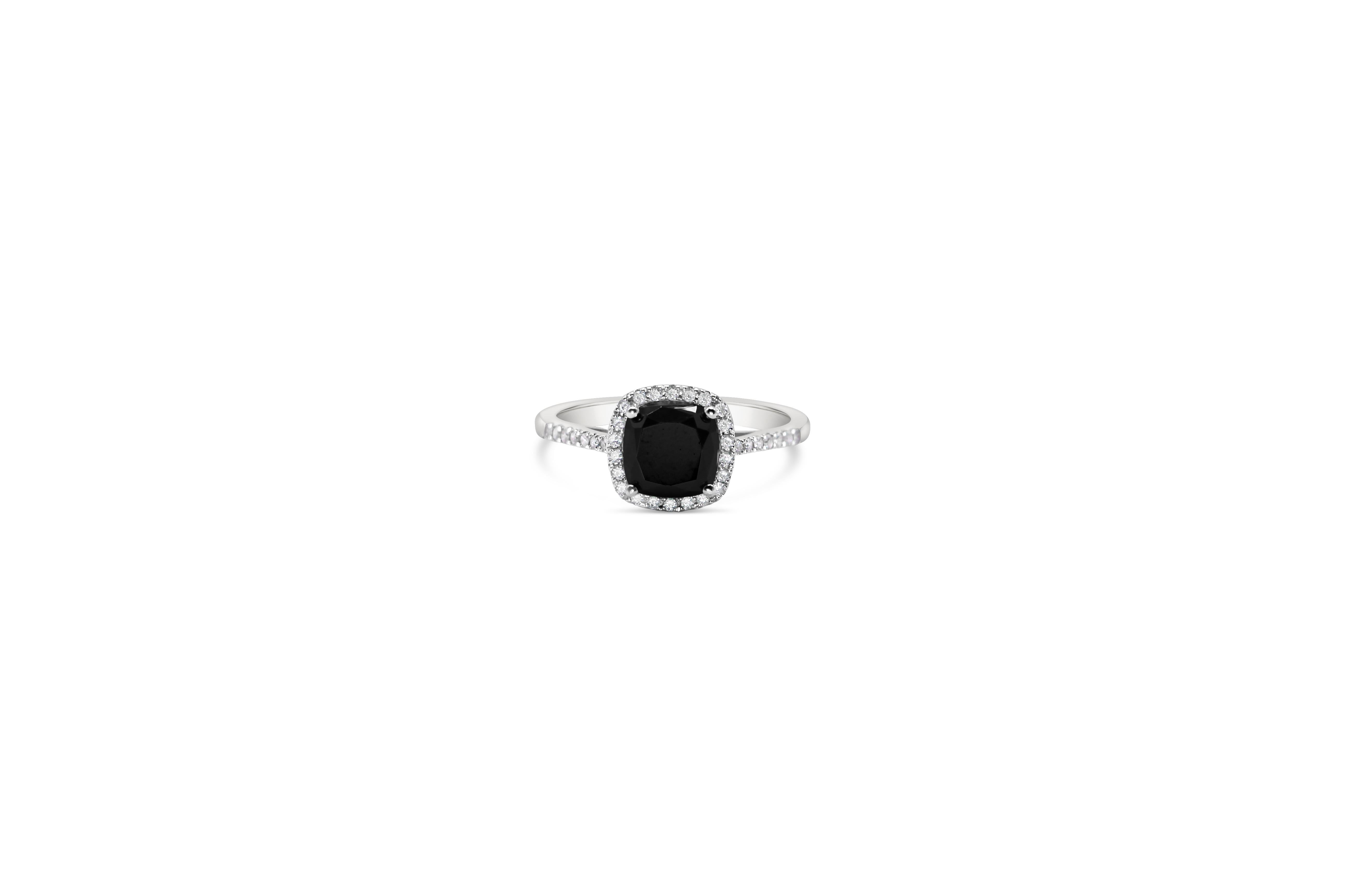 Black Diamond Cushion Cut Solitaire Ring in 18Kt  with White Diamonds Brilliant Cut. 
A unique handmade ring in 18Kt white gold. The main stone in the center is a rare  Black Diamond 1.85ct cushion cut which is set among four prongs. White diamonds