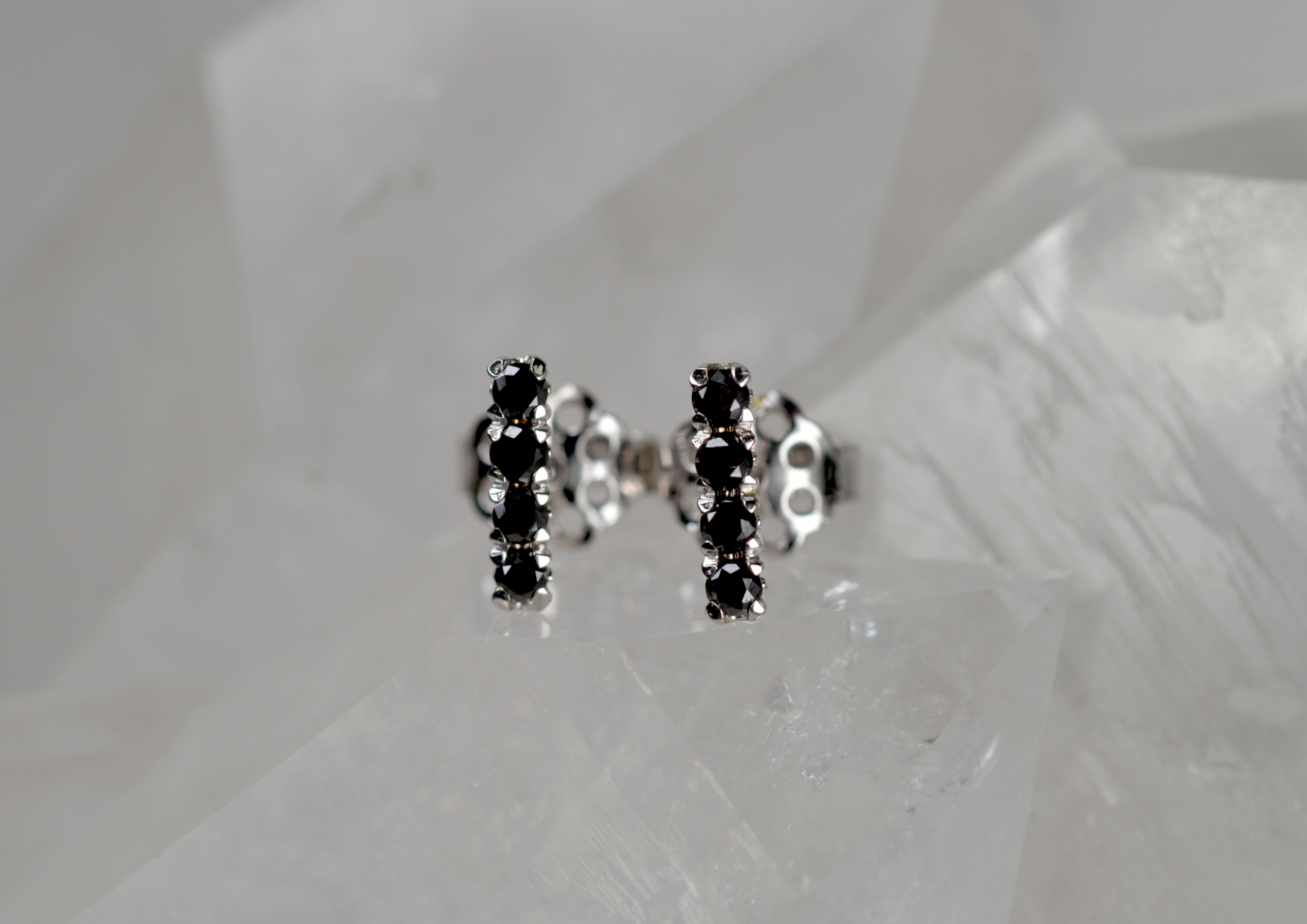 These earring studs are part of our Blossom Collection of mix and match pieces. This sublime pair of black diamonds is set on an 18k gold blossom flower collet, they can be worn alongside your favourite pair of earrings, our blossom hoops, or by