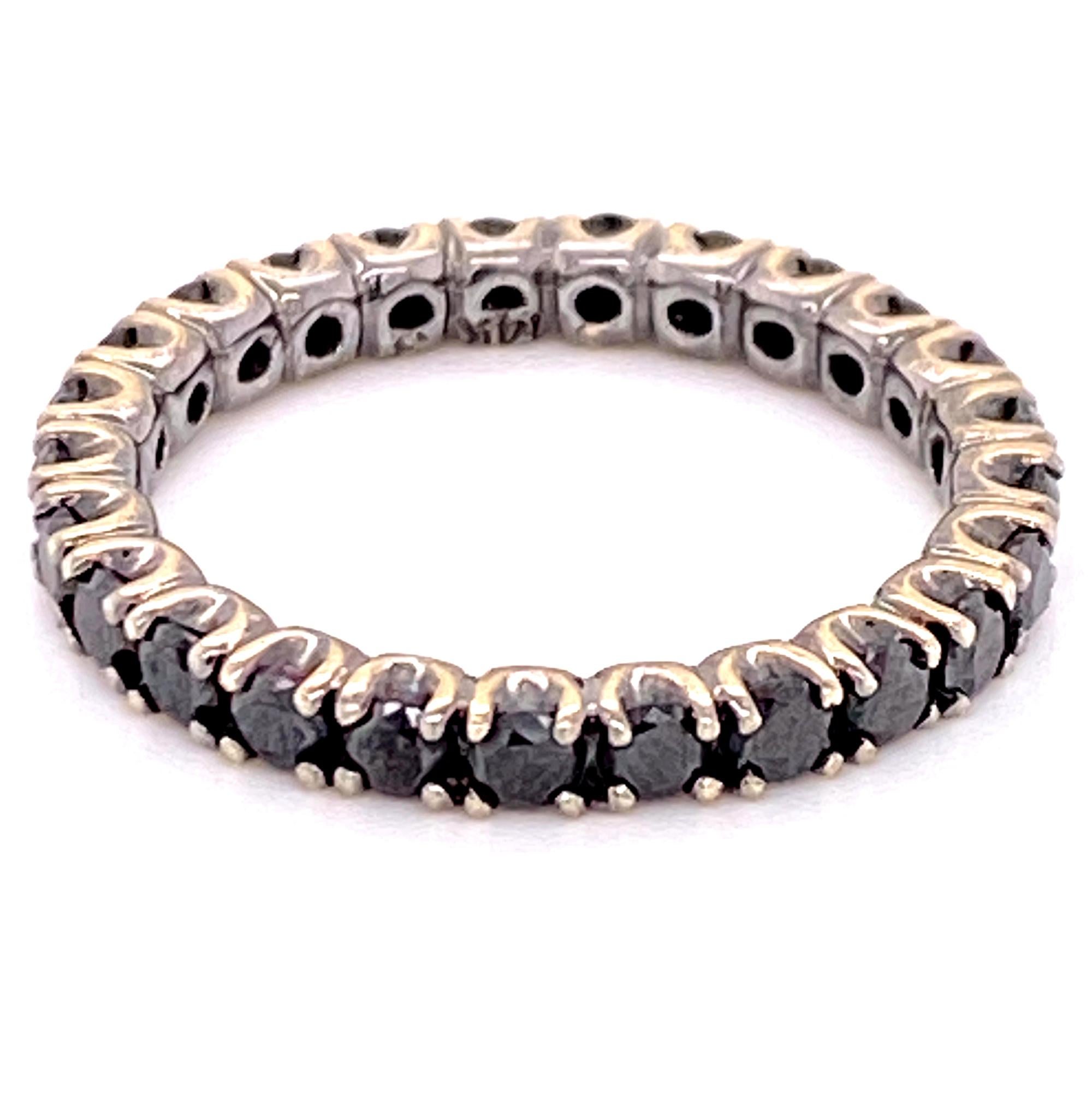 Stylish black diamond eternity band fashioned in 14 karat white gold. The diamond band is size 5 and features 1.14 carat total weight of round brilliant cut black diamonds. Looks great stacked with other bands or worn alone. 