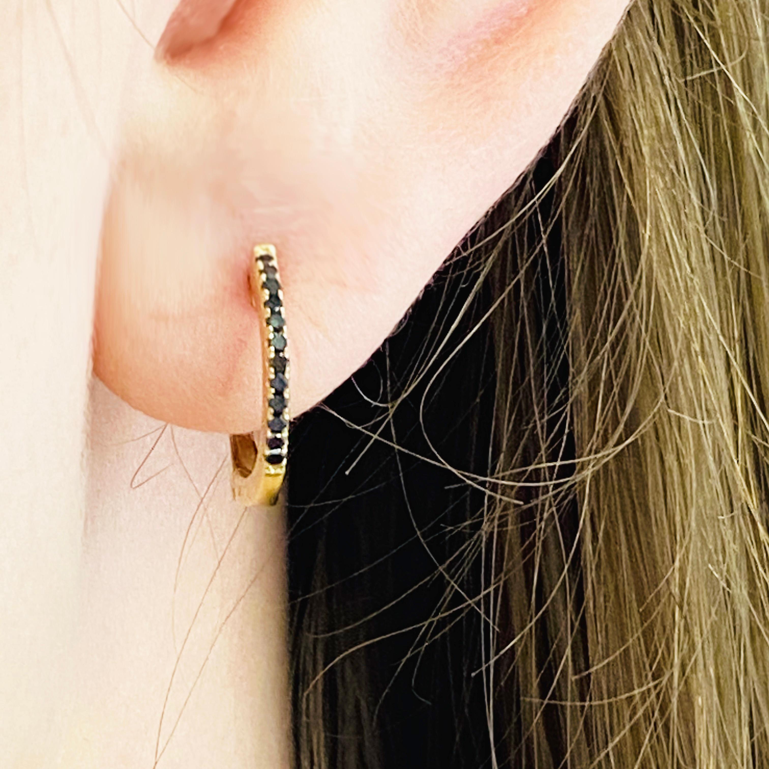 Edgy and modern black diamond huggies! Huggie earrings, mini hoops, have becomes the jewelry staple of the year! They are so easy and fun to wear. The small hoop earrings have round black diamonds set on the front in 14k yellow gold. The black