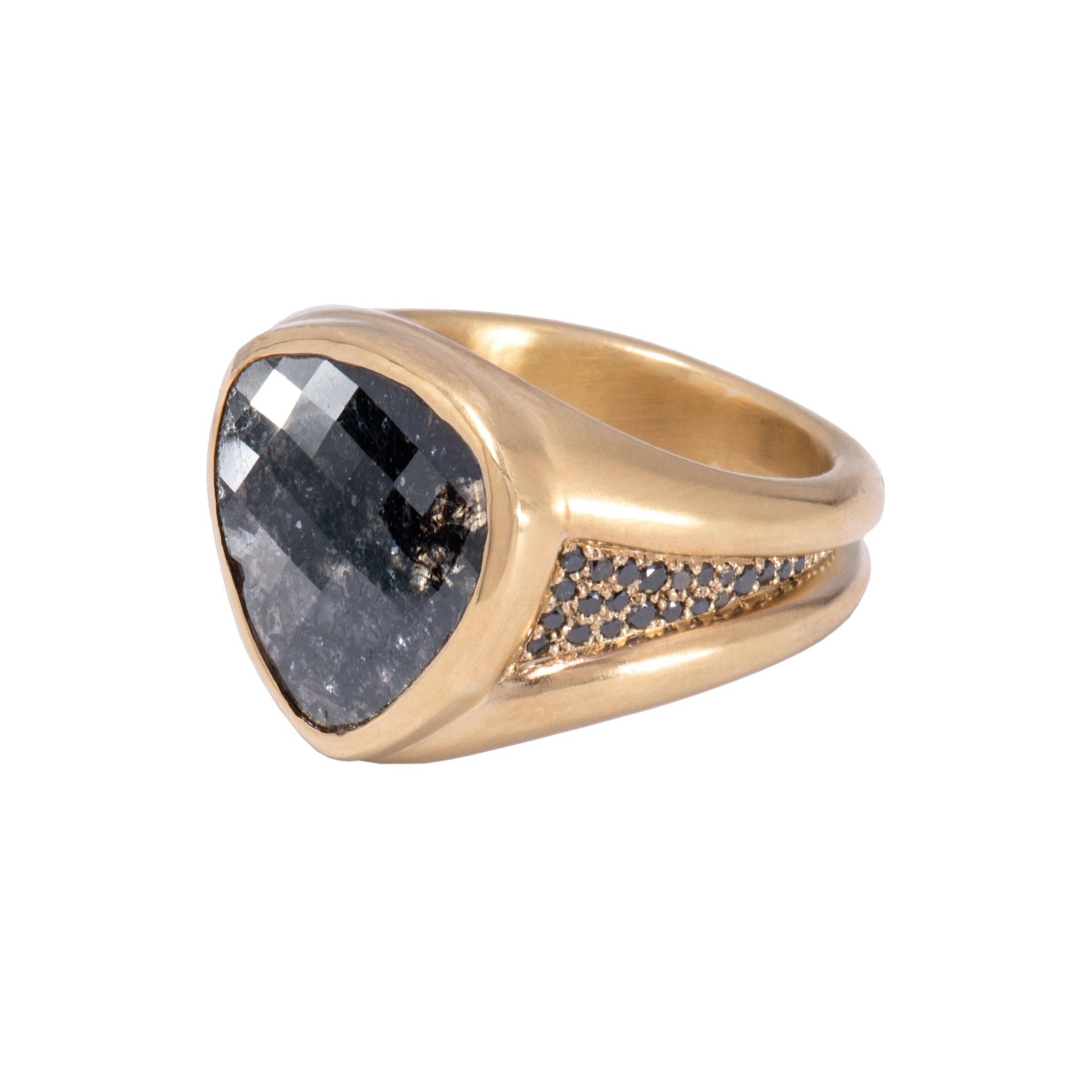 In the seats of power, the black diamond claims the throne. A glittering kaleidoscope is reflected in this 5.85 karat black diamond ring set in 18 karat gold. Tapered shanks are deep set and paved with a highway of more black diamonds for a regal