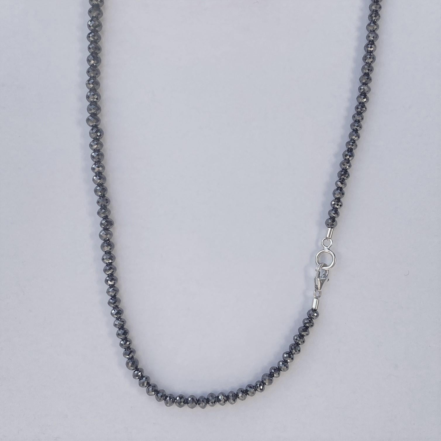 A strand of round faceted black diamond beads 51.11 total carat weight with 18k and 14k white gold clasp parts. This necklace was designed and made by llyn strong.