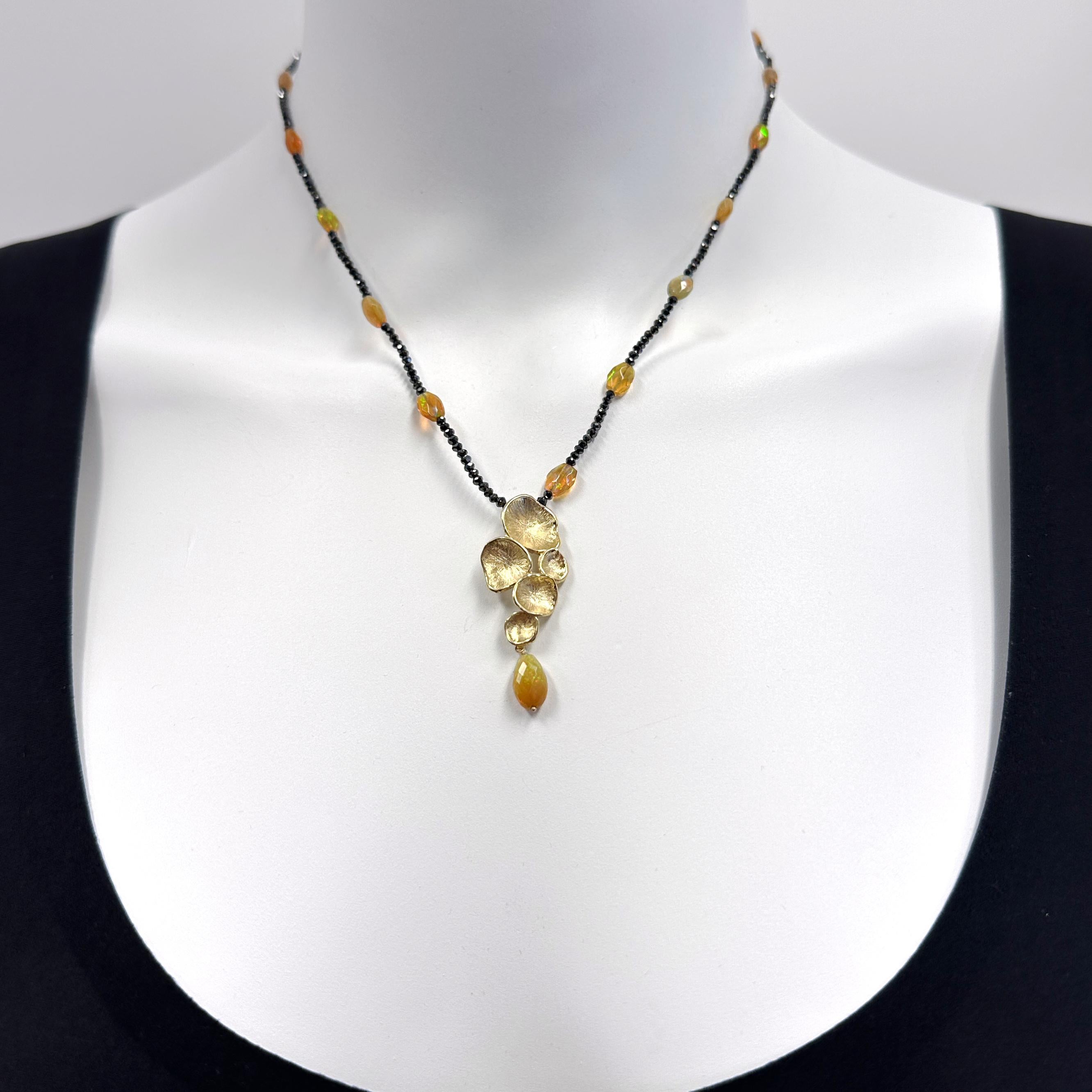 Eytan's design of cascading peperomia leaves is one he's used for many different pieces, but each piece is unique.  This time, he's made it into a pendant with a faceted opal bead drop to serve as the centerpiece on a station necklace of black