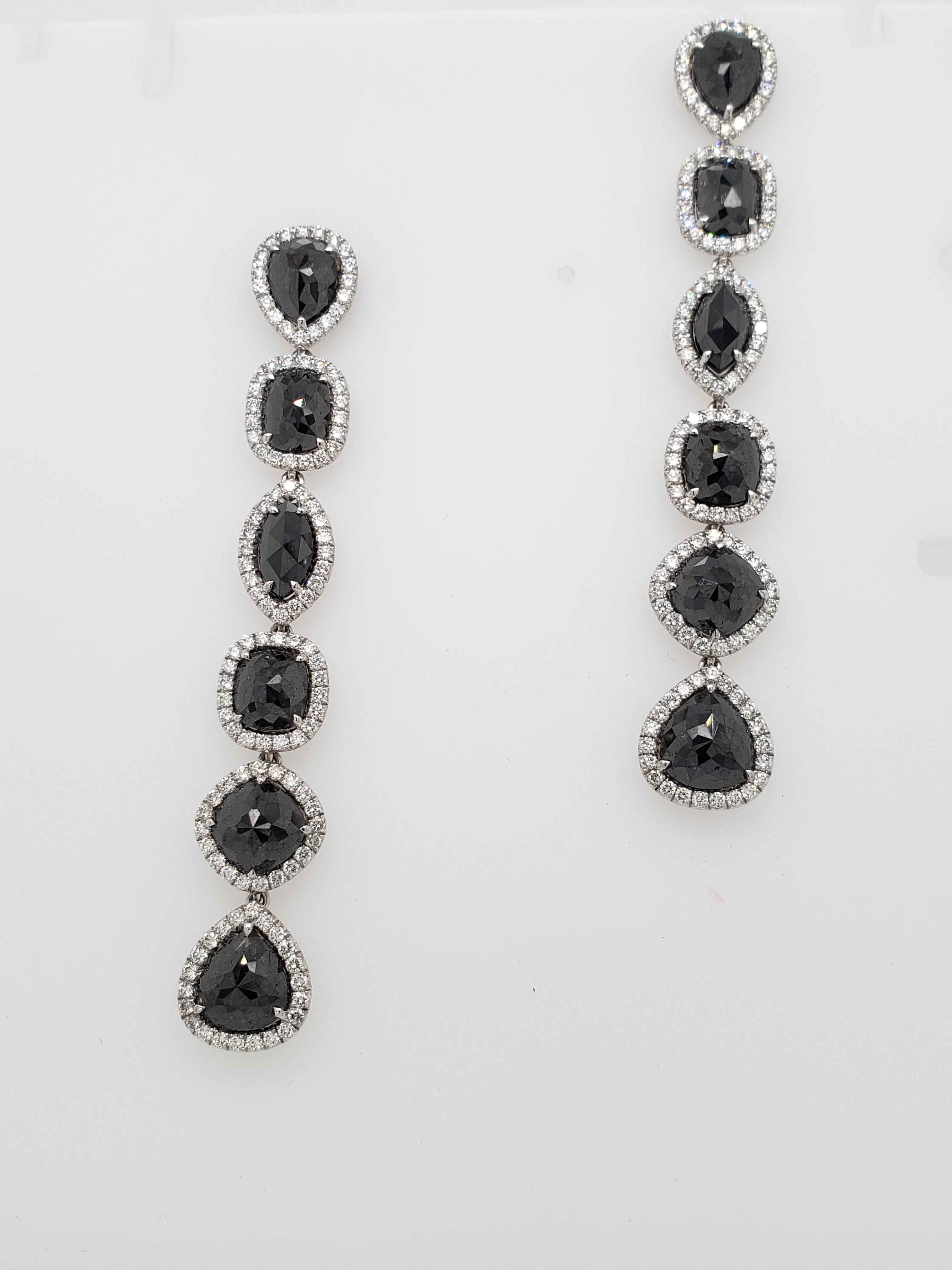 These fathomless Black diamond drop earrings feature 12 Rose cut Black diamonds in various shapes totaling 18.66 carats, edged in collection White pavé diamonds weighing 2.98 carats. Hand-crafted in 18K White Gold.
Clean & Chic; Fall into the abyss