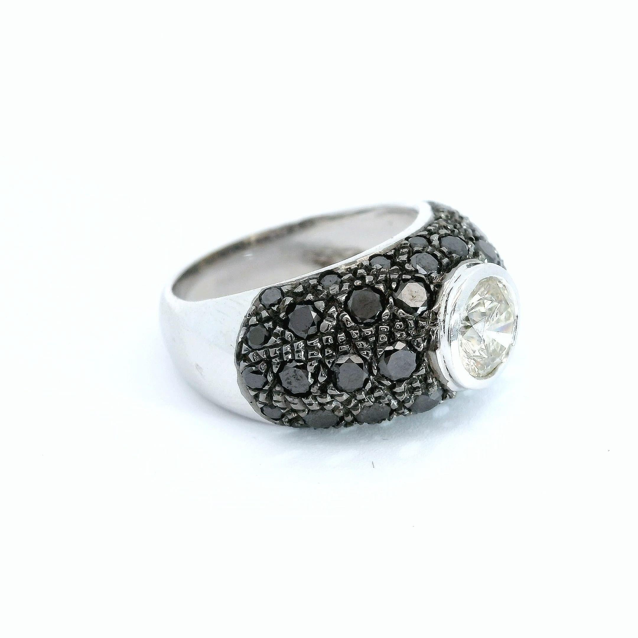 This exquisite ring effortlessly blends bold glamour and understated elegance. Crafted from luxurious 18-karat white gold weighing an impressive 6.99 grams, the band is pavé-set with a mesmerizing array of 1.19 carats of black diamonds. These