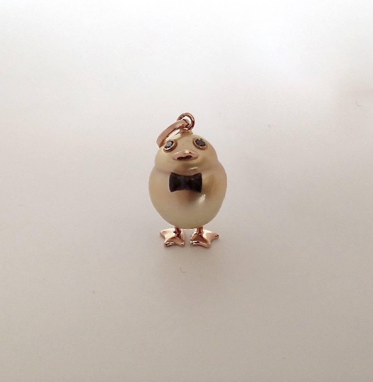 A duckling made with a gold Australian pearl and two black diamonds in its eyes.
Ring, beak and legs made in pink gold.
The bow tie is in white gold plated in black rhodium.
This one as all my pearl pendants is really handmade and is a unique piece.