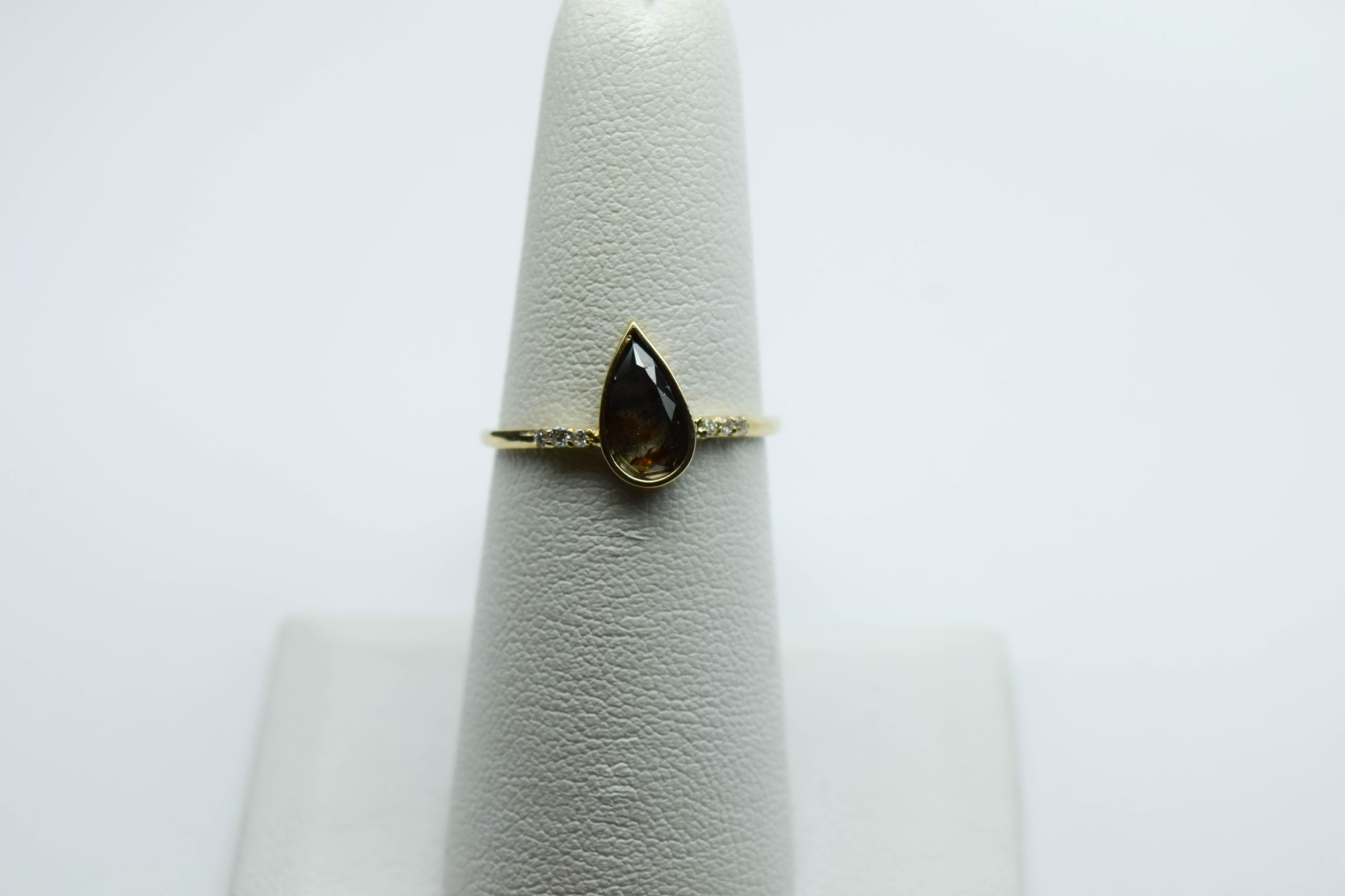 
Stunning one of a kind pear shape daimond ring made in yellow gold, this is not your classical ring, the stone is a natural black diamond the pattern inside the diamond is so mysterious and cannot be easily found in other rings. I love natural