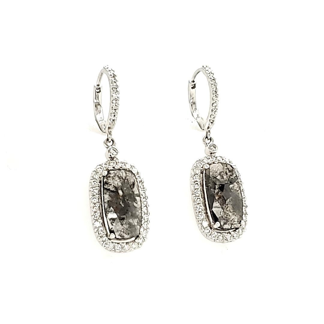 Black Diamond Slice And White Diamond Earrings:

A highly unusual yet striking piece, this earring is composed of two natural Black Diamond Slices weighing 5.12 carat, with a halo of White Diamonds weighing 1.13 carat. Black Diamonds are not seen as