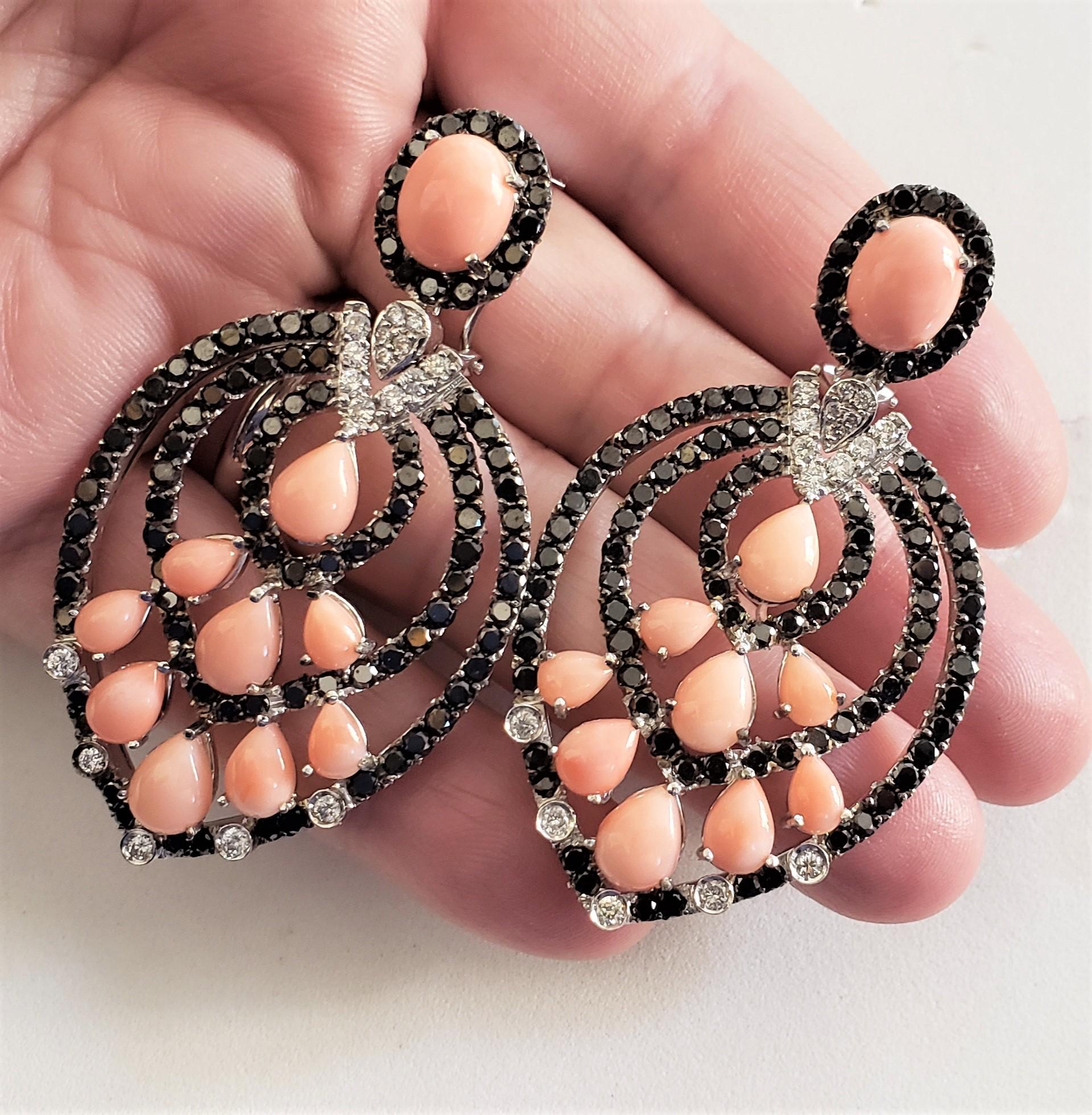 Each chandelier earring encrusted with 98 Natural Black diamonds (natural black diamonds sparkle differently then any other black gem stones) and 12 natural white diamonds (G-H in color, SI1 clarity). Dangling part of each earring set with 9 Pear
