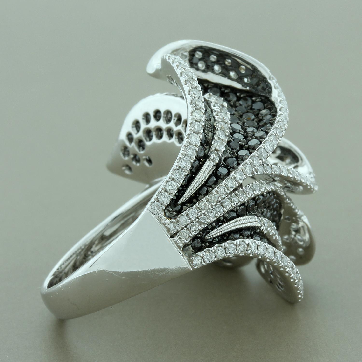 An intricately designed cocktail ring unlike any other. Five calla lilies in a sideway bouquet featuring 2.78 carats of round cut deep black diamonds and 1.82 carats of round cut white diamonds. Set in 18K white gold with a black rhodium finish. A