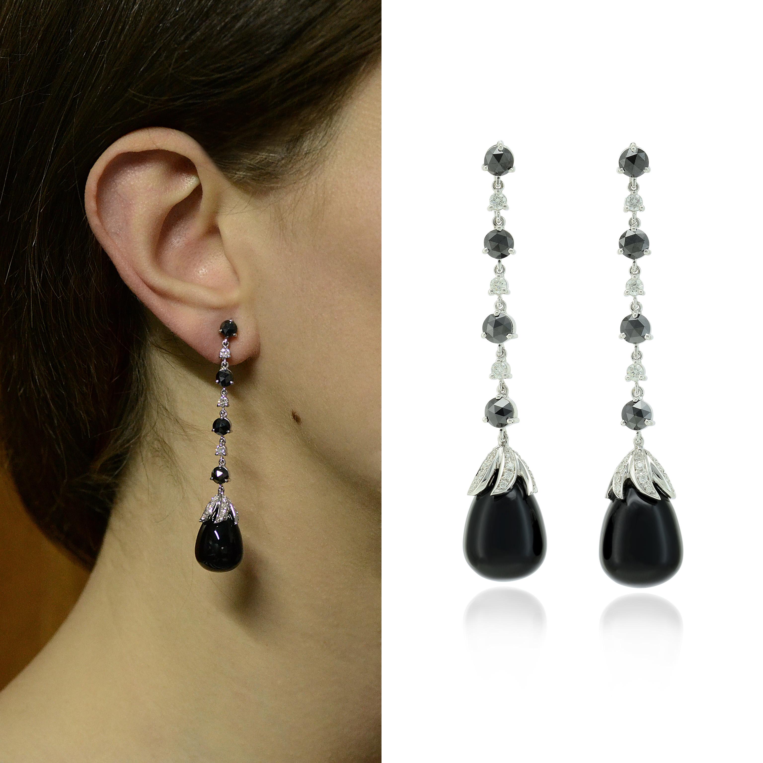 Handcrafted in Italy, in Margherita Burgener family workshop, the flexible long earrings feature a rose cut black diamond alternate to a colorless round diamond, ending by a onyx cabochon drop with diamond pavé set leaves motif. 

Fitting and
