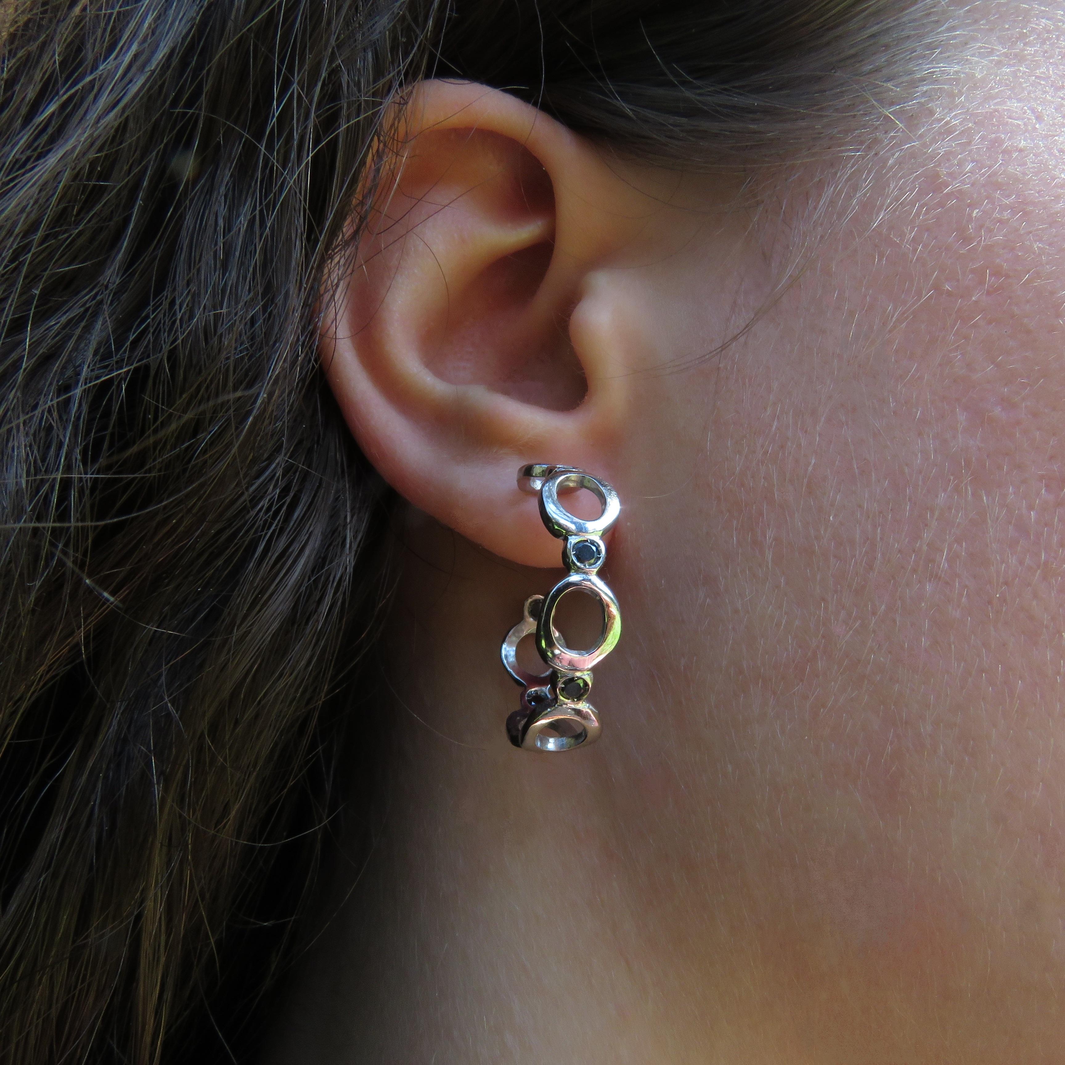 18 karat white gold hoop earrings with 12 black diamonds 0.40 ctw. The diameter of each earring is 36 mm / 1.417 inches.
These earrings are marked with the Italian Gold Mark 750 and Botta Gioielli brandmark 716MI. They are part of Bubble