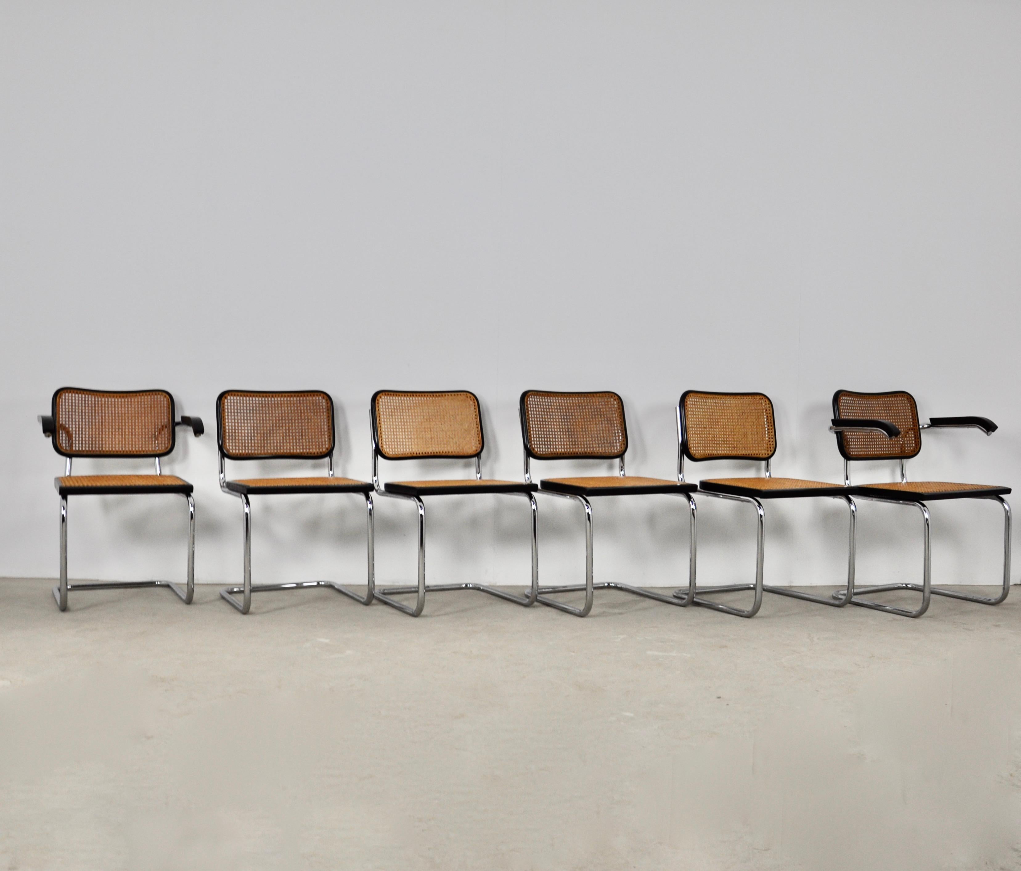Set of 4 chairs and 2 armchairs in metal, wood and cane. Wear due to time and age of the chairs (see photo) 
Seat height: 46cm. 2 chairs still have their stamp (Cidue).