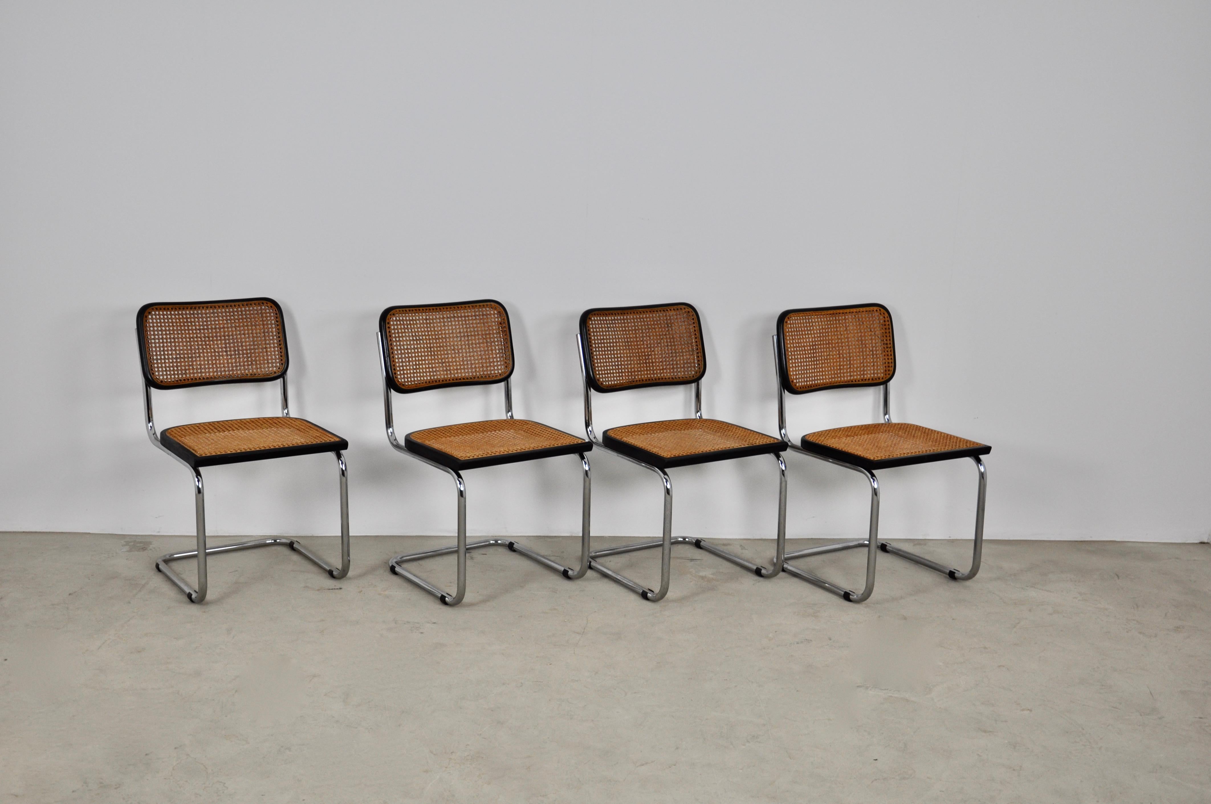 Set of 4 chairs in chromed metal, black wooden structure and wickerwork.

Wear and tear due to time and age of the chairs. Measure: Seat height 46cm.