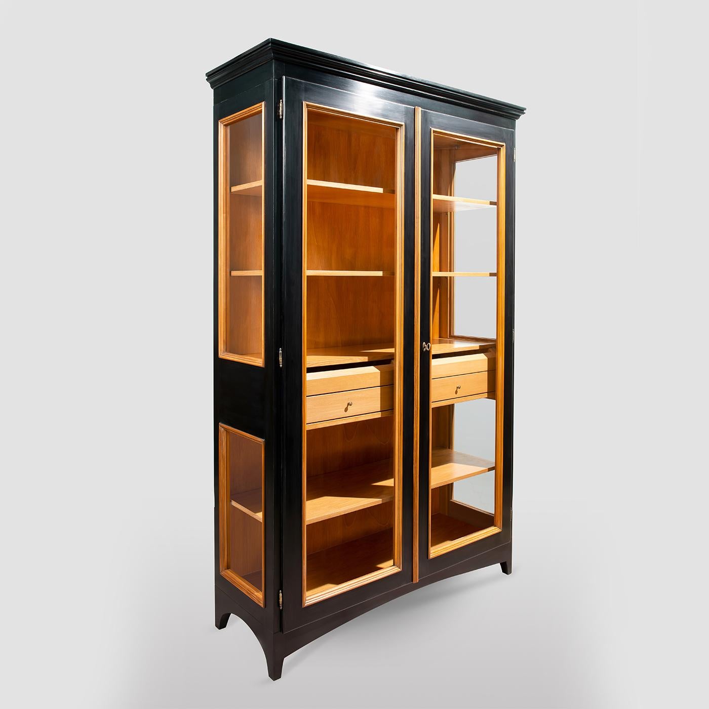 Merging contemporary aesthetic and Italian cabinet-making tradition, this striking display cabinet delivers a masterclass in modern Italian furniture design. The tall Toulipier wood frame features two front glass doors and lateral glass panels to