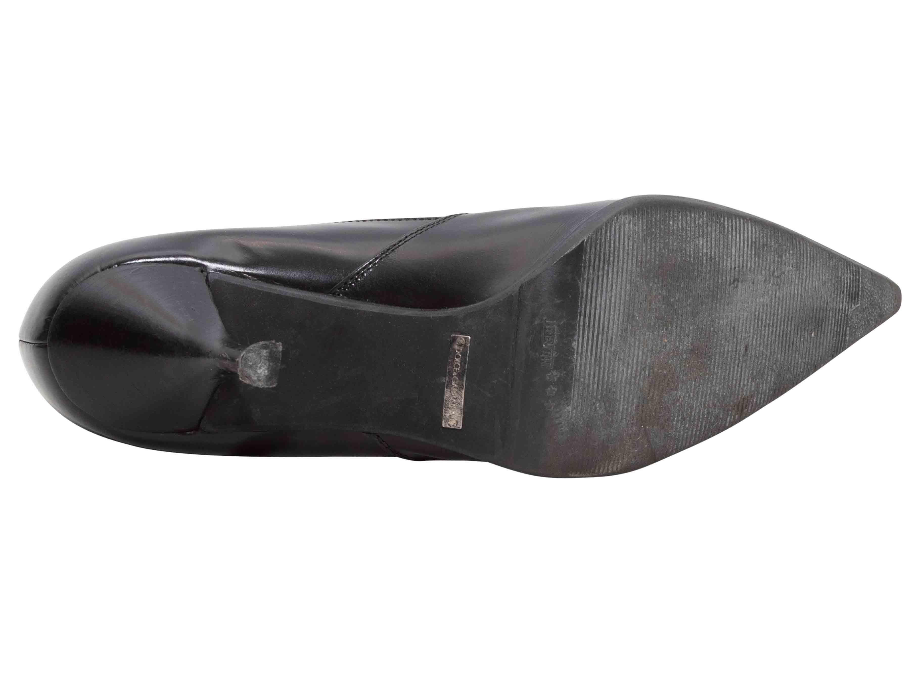 Black patent leather and suede pointed-toe heeled booties by Dolce & Gabbana. Silver-tone hardware. Zip closures at outer sides. 4
