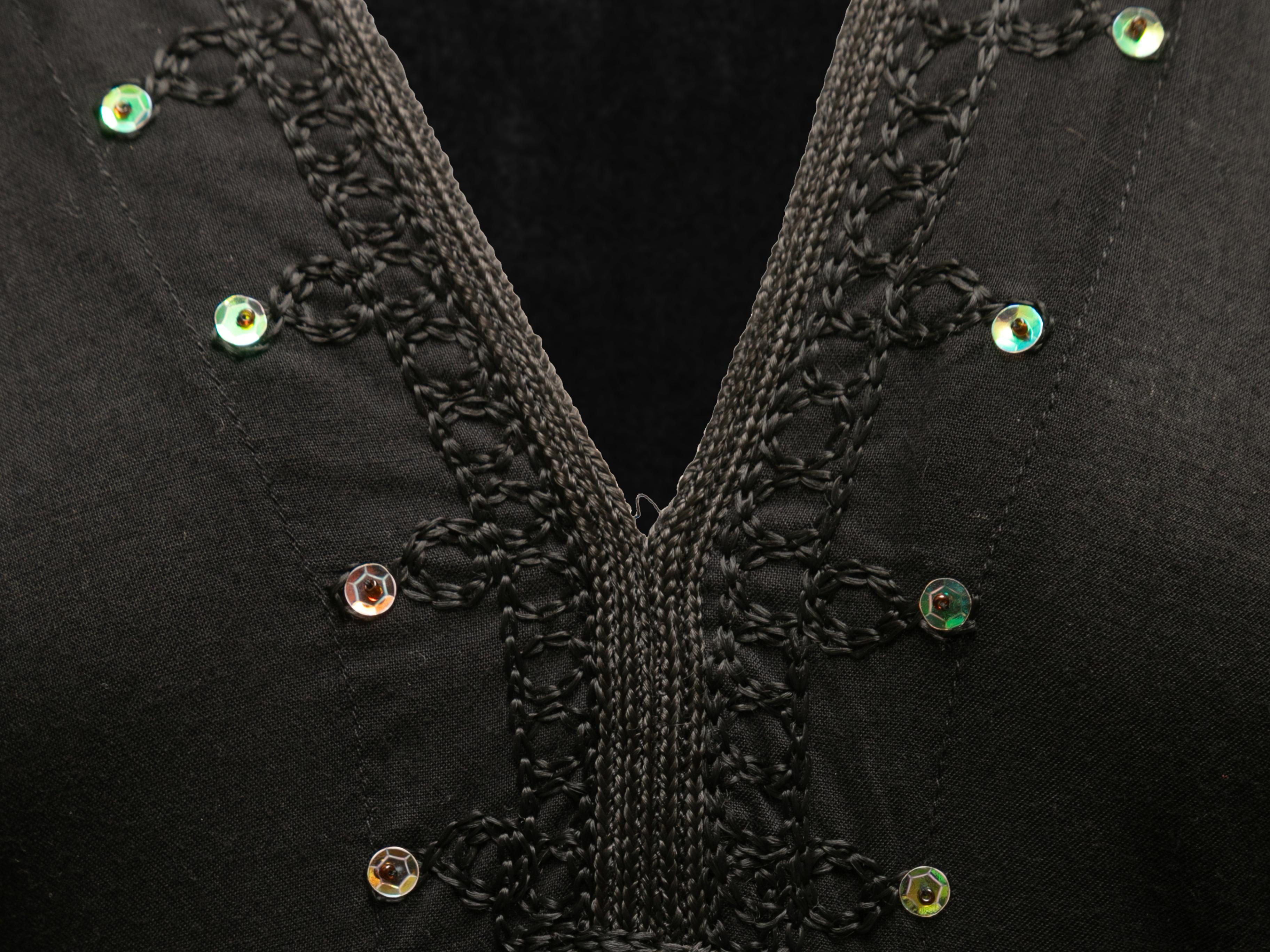 Black long sleeve maxi dress by Dolce & Gabbana. Sequin trim throughout. V-neck. 40