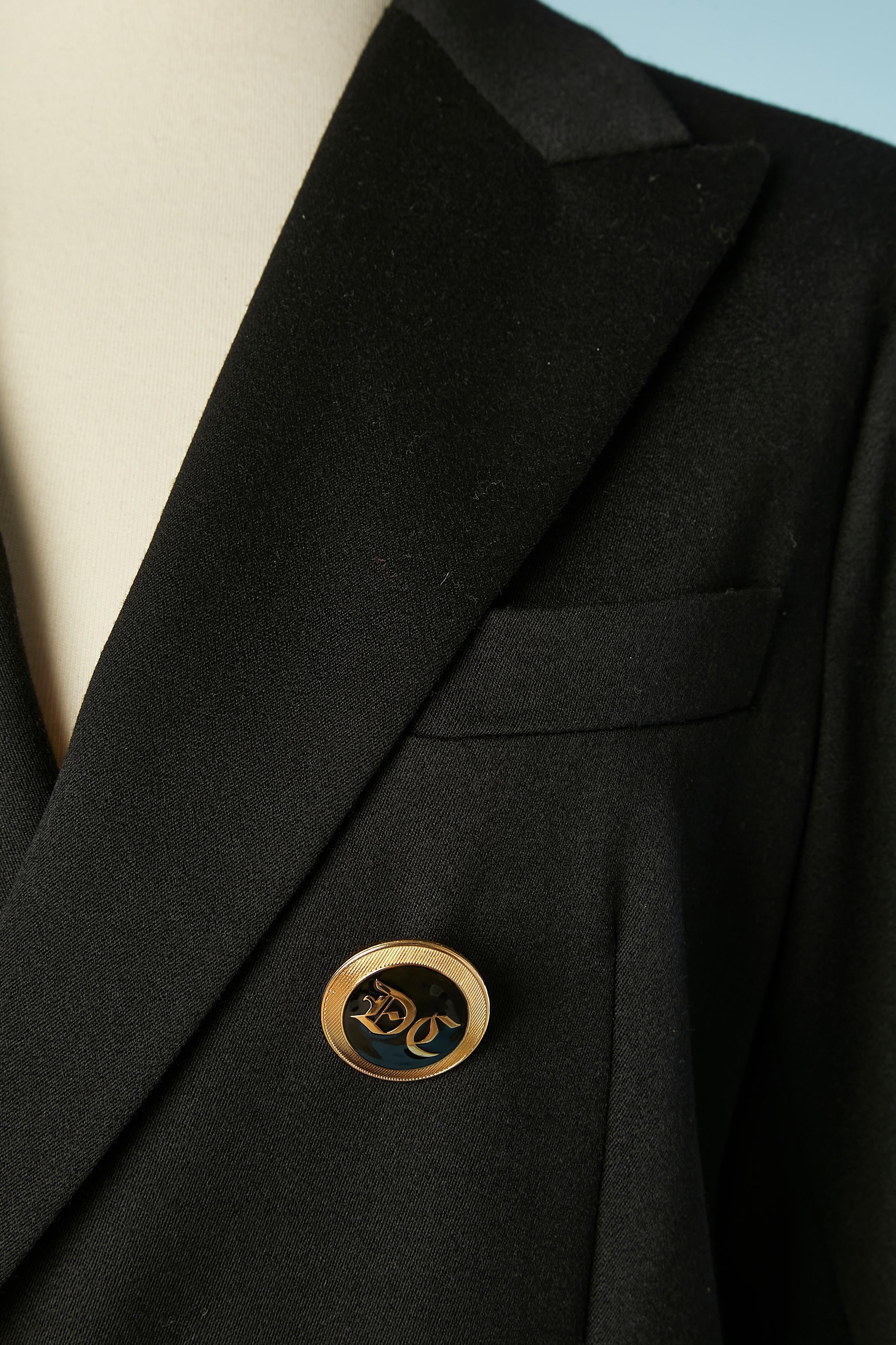 Black double-breasted blazer with gold passementerie ribbons. Branded buttons. Fabric composition: 100% wool. Sleeve lining composition 65% rayon, 35% polyester. White lining on the shoulders: 50% cotton, 50% rayon. 
SIZE 42 (It) 38 (Fr) 8 (US) 