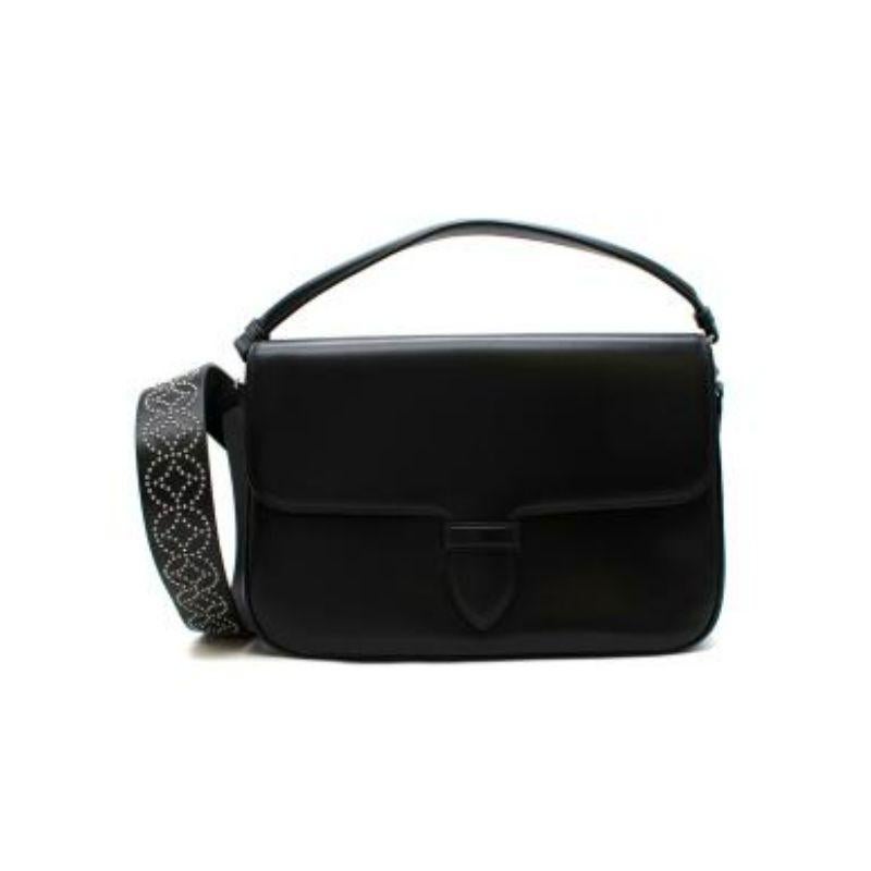 Alaia Black Double Pocket Top Handle Bag with Studded Shoulder Strap
 
 
 
 -Detachable studded shoulder strap 
 
 -Two fold over sections 
 
 -Silver wear hardware 
 
 -Rolled up top handle 
 
 -Mirror attachment 
 
 
 
 Material: 
 
 
 
 Leather 
