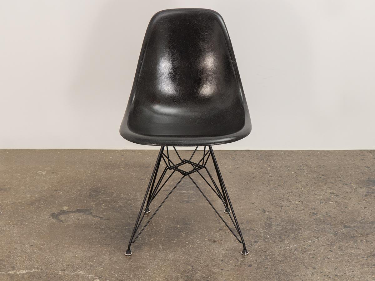 Original 1960s black fiberglass shell side chair designed by Charles and Ray Eames for Herman Miller. The shell has its original finish with distinct thread texture. Available as shown — mounted on a new Eiffel base. Additional base styles
