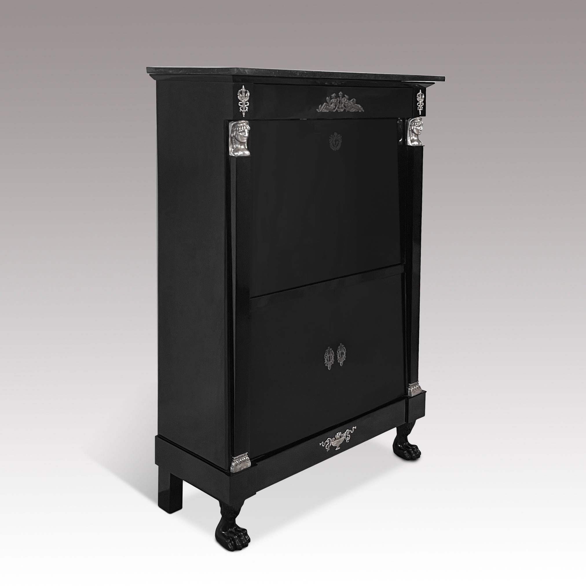 Antique ebonized Empire secretary with silver-plated bronze fittings and original black marble top. 
The piece was made in France in the 19th century and is a perfect example of the days of the French Empire. The front of the ebonized and shellac