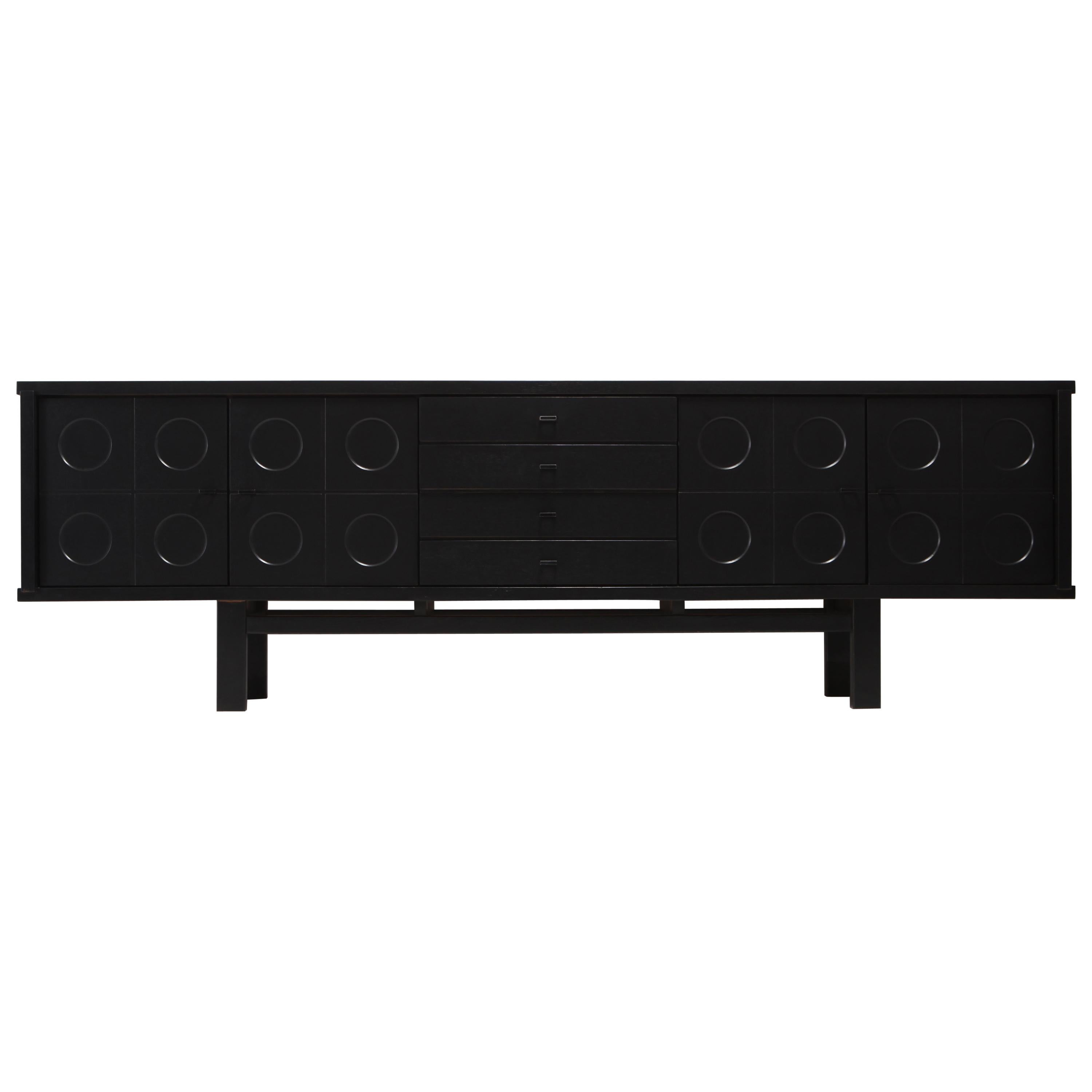 Brutalist sideboard made out of ebonized oak.
The symmetry of this design combined with the graphical pattern on the doors is adding a Brutalist expression to this storage piece. It contains plenty of storage possibilities with shelves on the