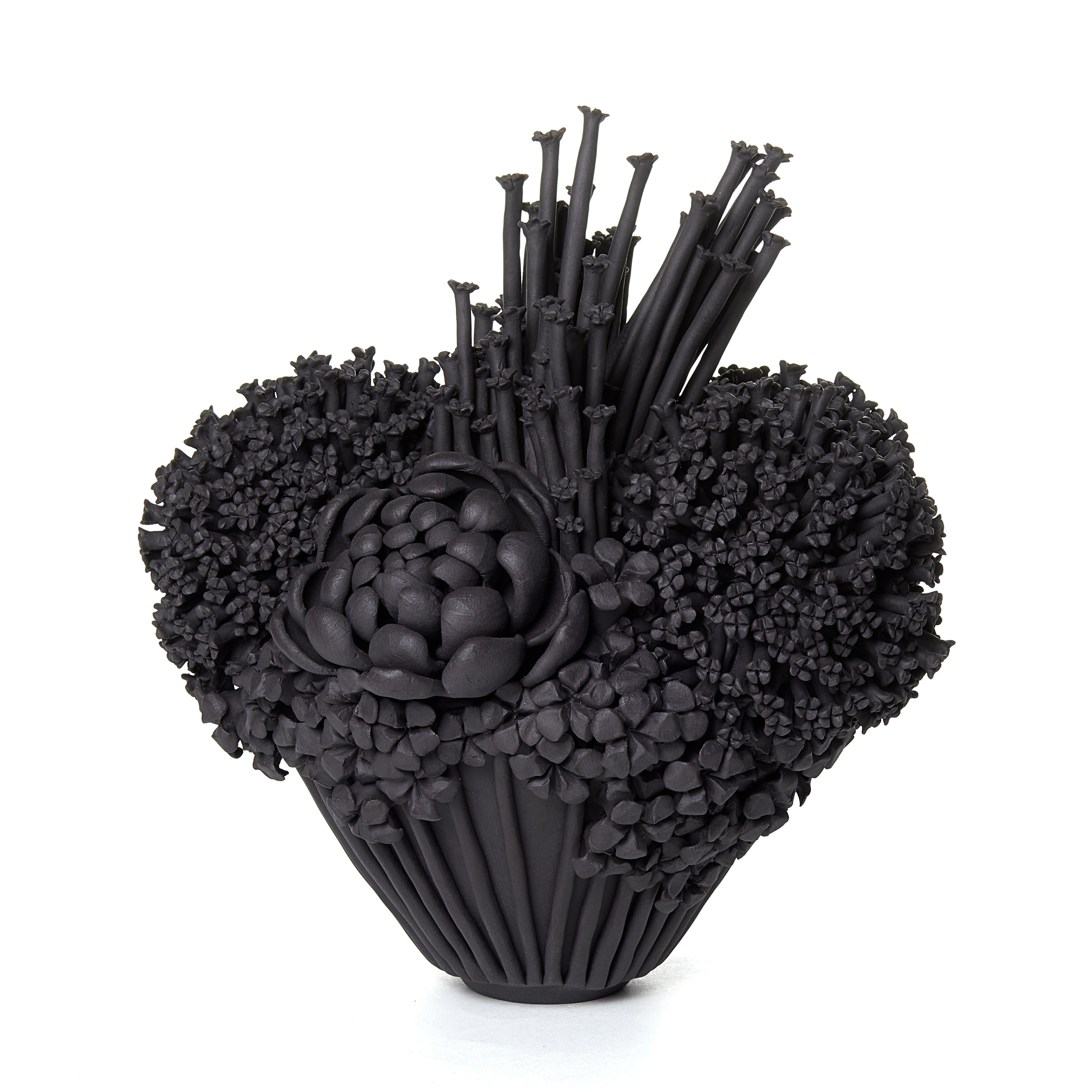 Black Efflorescence II is a unique hand-sculpted stoneware sculpture completely covered in a variety of flowers and blooms, each individually handmade by the British artist Vanessa Hogge.

Vanessa Hogge breathes life into her clay in the form of