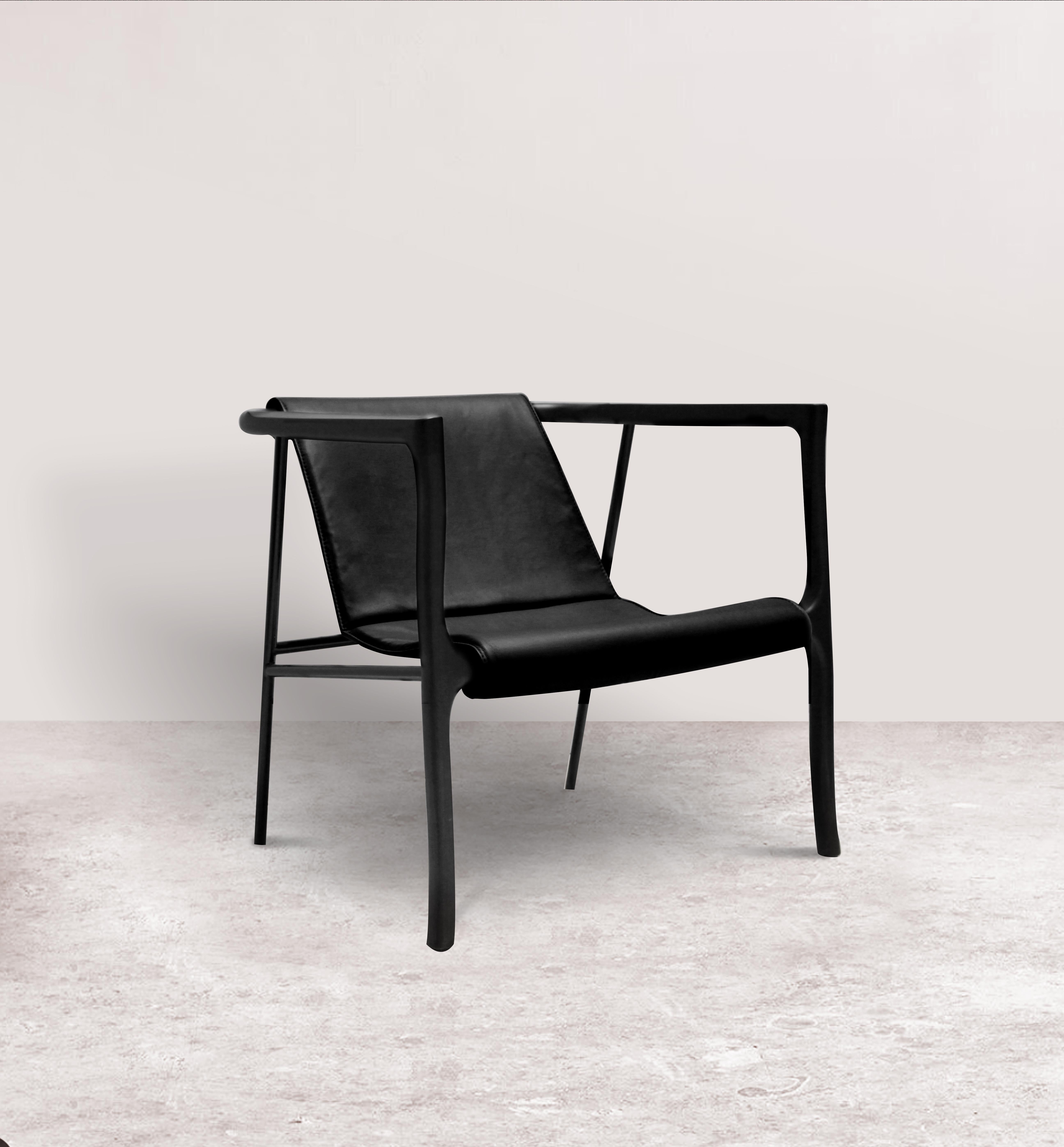 Black Elliot armchair by Collector
Materials: Solid oak wood armrests.
Black Lacquerd metal frame structure. Uphostered in leather.
Dimensions: W 85 x D 75 x H 72 cm, SH 44 cm 
Depending on the material the price may vary.

With solid and curved