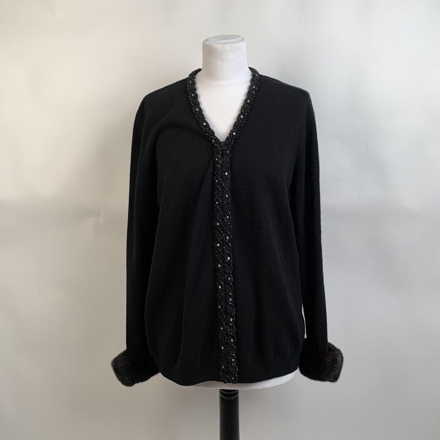 Black embellished cardigan signed Anna Molinari for Blumarine. The cardigan features beads embellishment on the front and on the neckline, zip closure and fur trim on the cuffs. Composition tag is missing. It seems to be wool. Size: 46 IT, 40 D (The