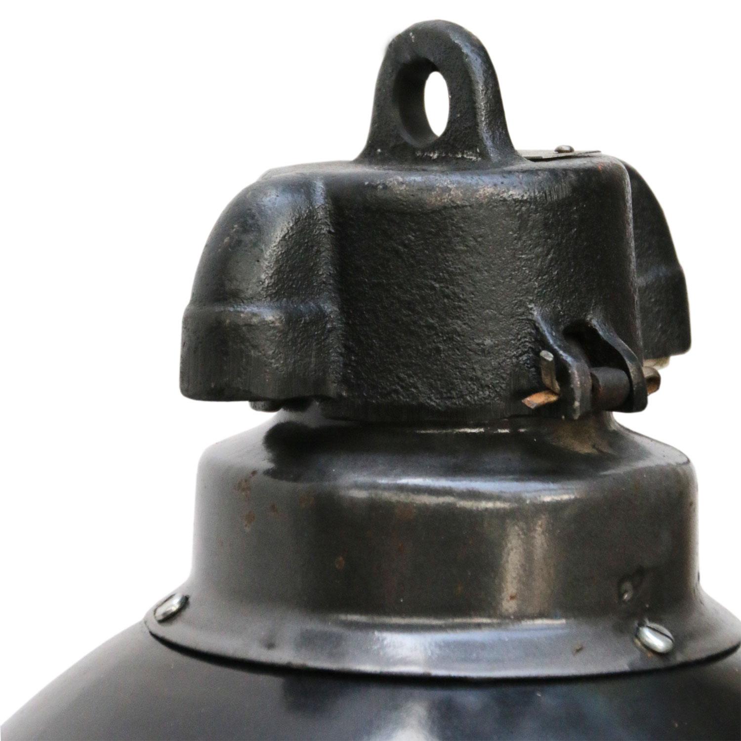 Bauhaus Classic from the 1930s. Black enamel Industrial hanging lamp.
Cast iron top. White interior.

Weight: 1.7 kg / 3.7 lb

Priced per individual item. All lamps have been made suitable by international standards for incandescent light bulbs,