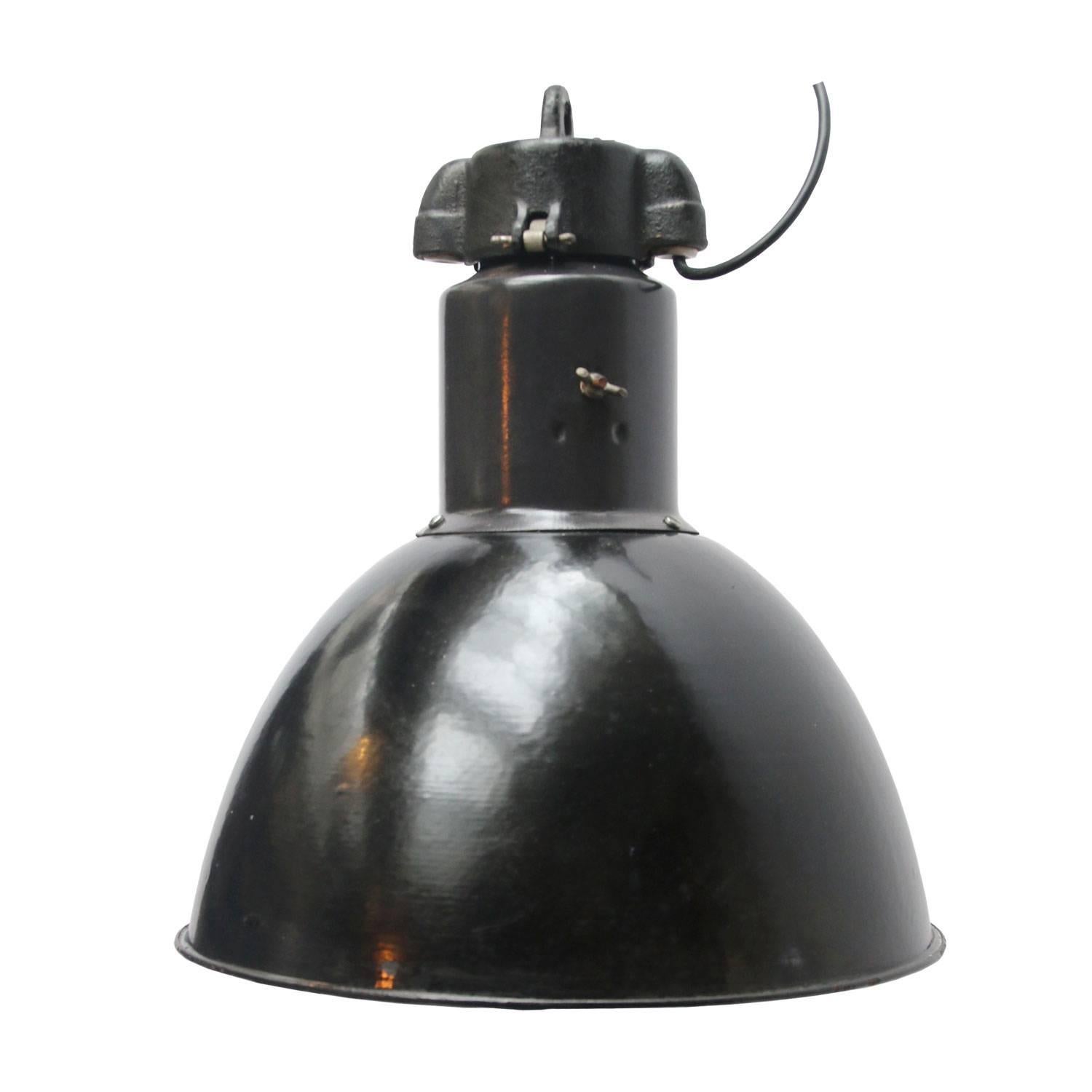 Bauhaus Classic from the 1930s. Black enamel industrial hanging lamp. Cast iron top. White interior.

Weight 2.4 kg / 5.3 lb

Priced per individual item. All lamps have been made suitable by international standards for incandescent light bulbs,