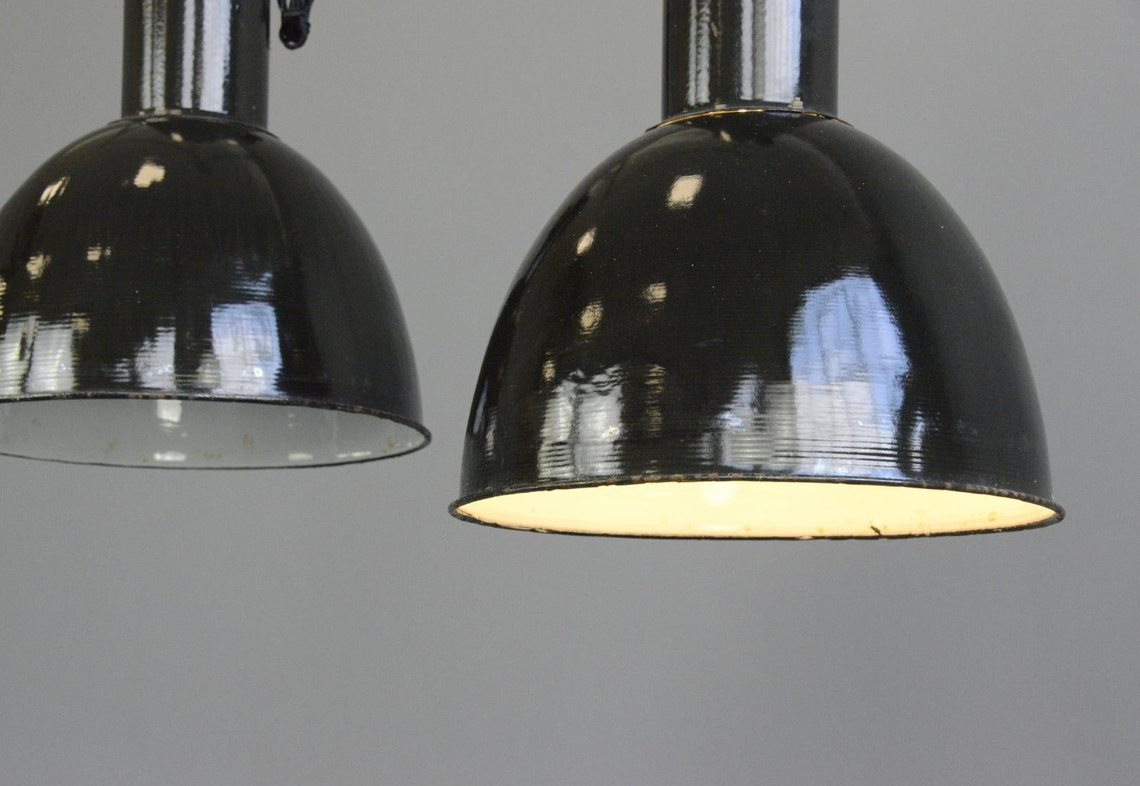 Black enamel Bauhaus Factory lights, circa 1930s

- Price is per light
- Vitreous black enamel shades
- White enamel inner reflectors
- Cast iron tops
- Comes with 100cm of black braided cable
- Comes with chain and ceiling hook
- Takes E27