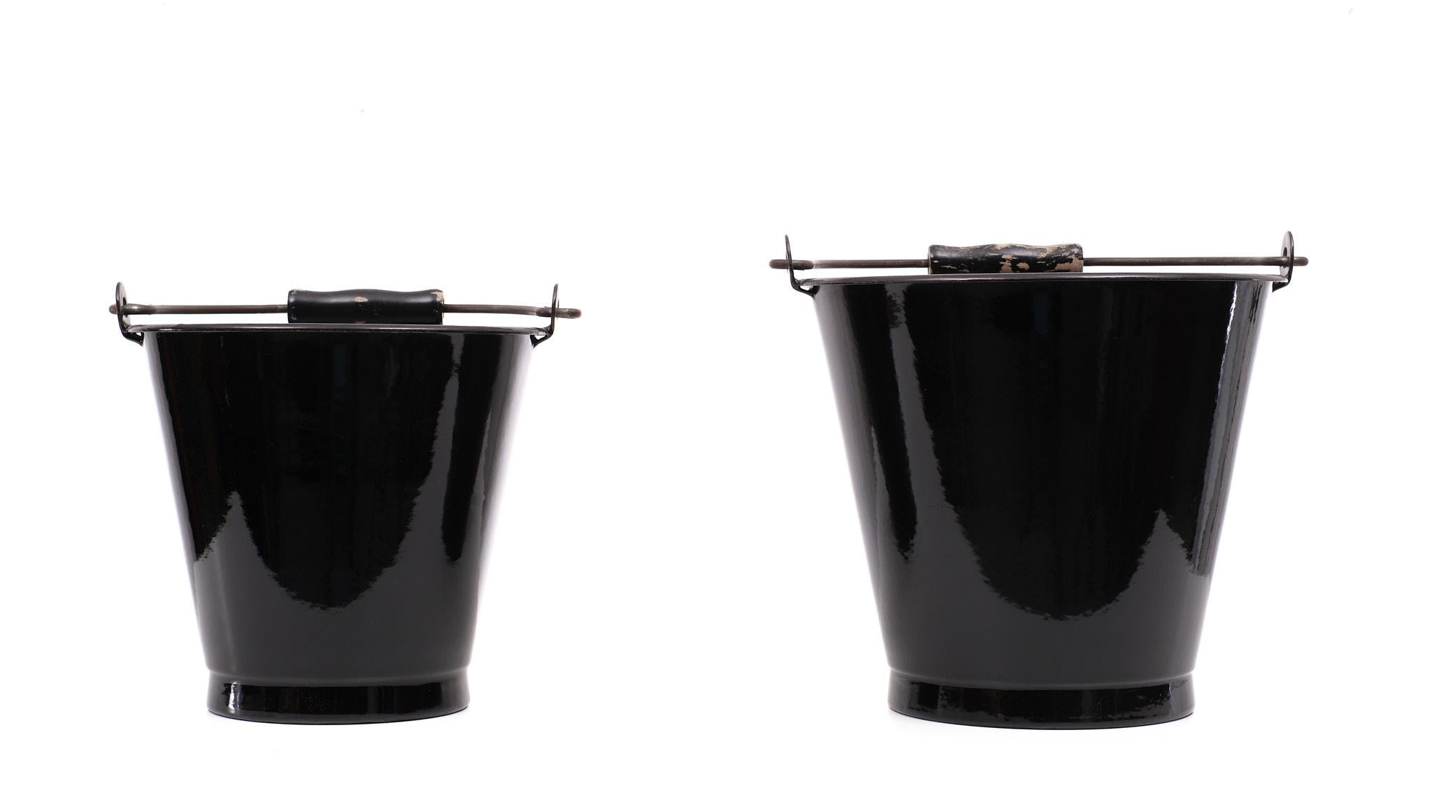Unique set of buckets. These set bought in the 1950s was never used.
so new old stock. In a stunning Black Enamel color. Grey Enamel inside.
There is only some paint lose on the handles. I can fix that if you want. The buckets are really like new.