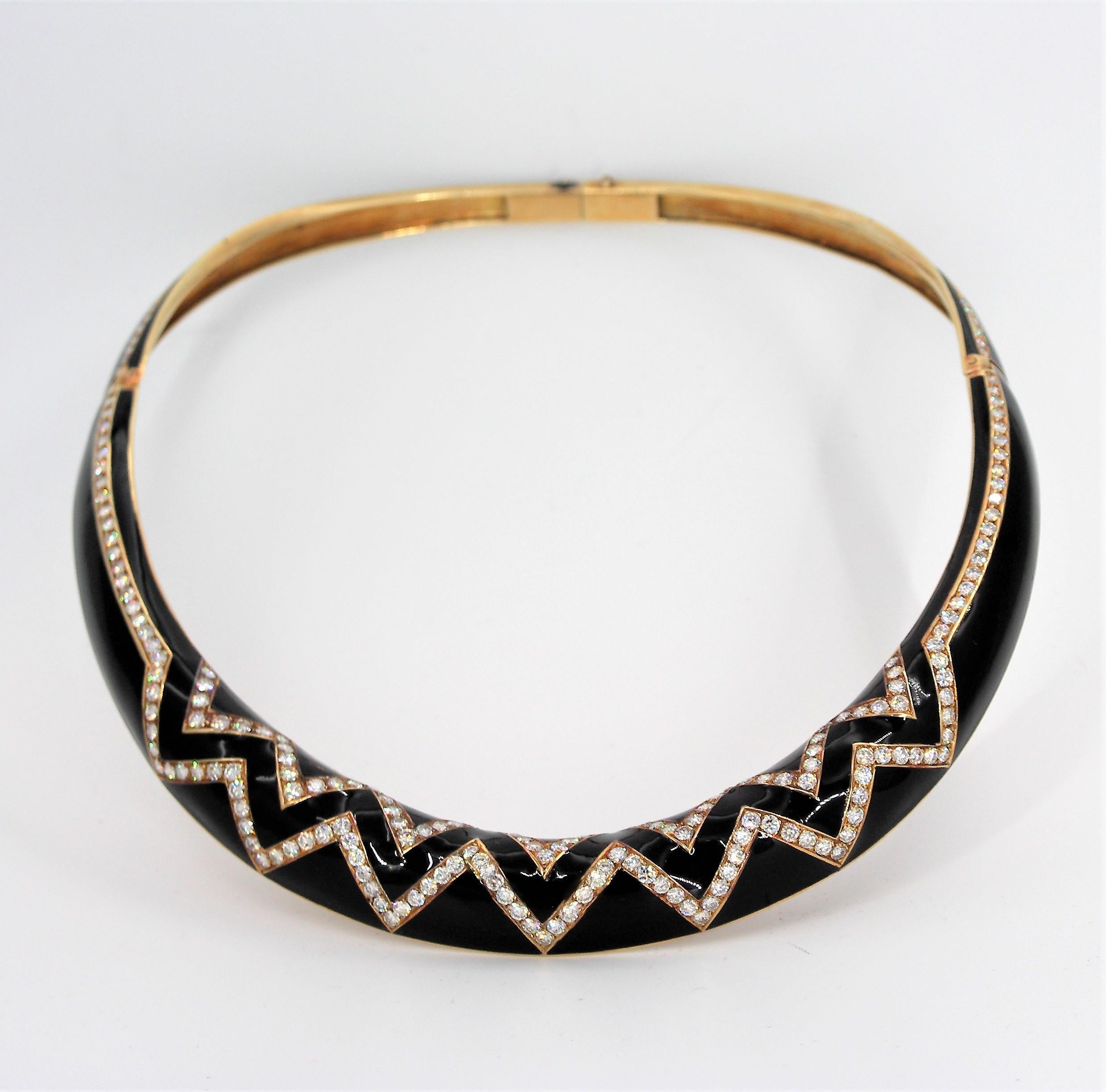 Made of 18K yellow gold, this tailored, rigid, collar is set with assorted round brilliant cut diamonds weighing an approximate total of 9.00ct. of overall H color and VS2-SI1 charity.
The black enamel goes all the way around the collar and is in