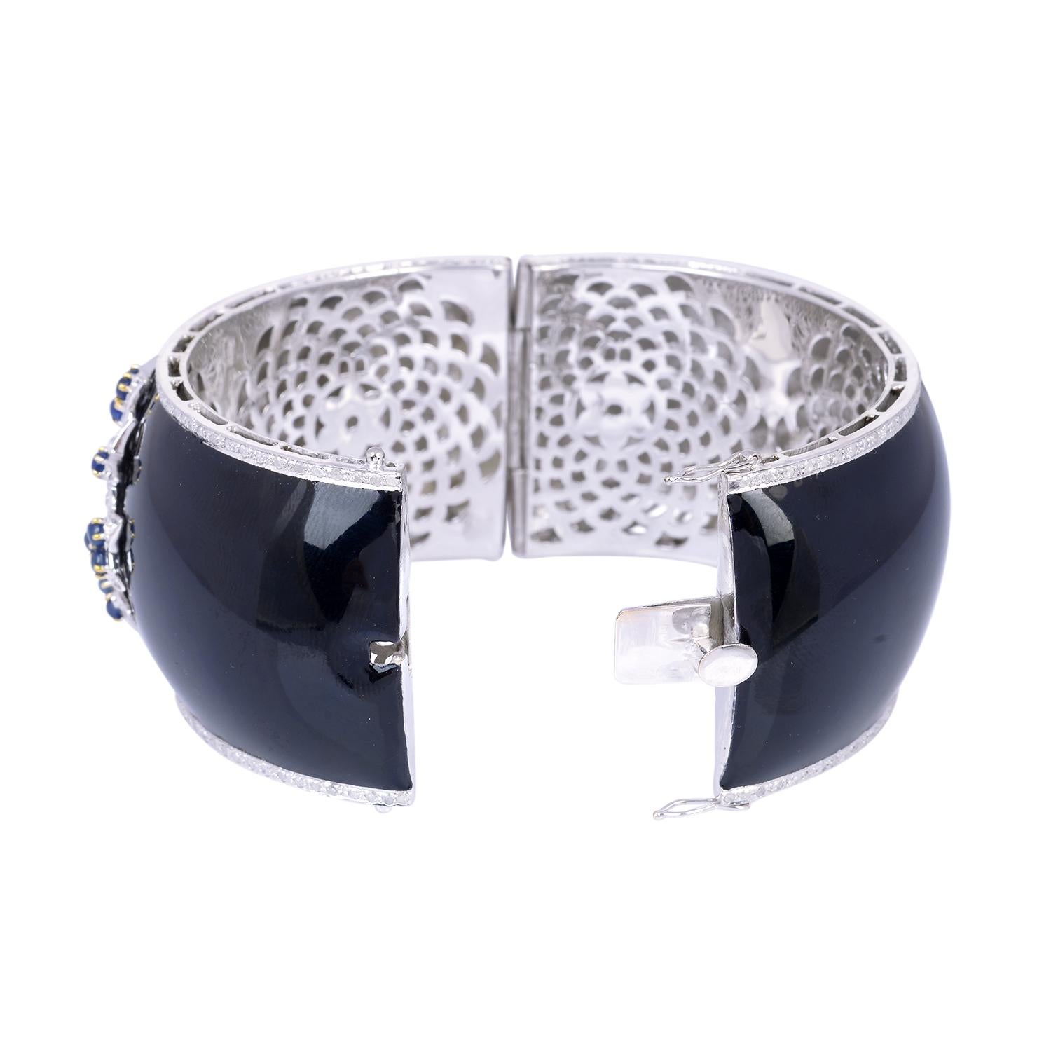 A beautiful enamel bracelet cuff handmade in 14K gold and sterling silver.  It is set in 3.0 carats sapphire and 2.72 carats of sparkling diamonds. Clasp Closure.

FOLLOW  MEGHNA JEWELS storefront to view the latest collection & exclusive pieces. 