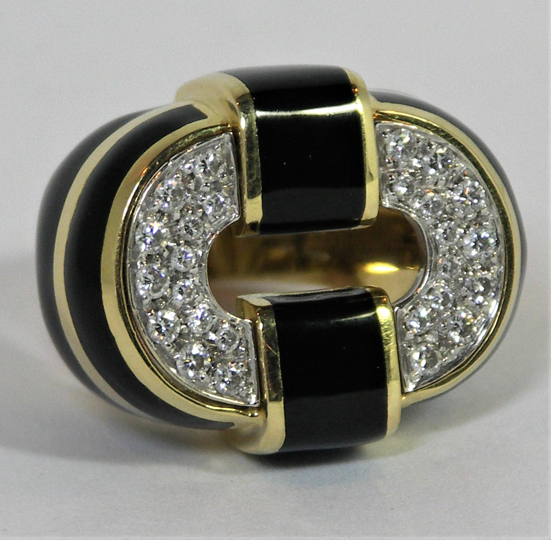 Made of 18k Yellow Gold, this striking black enamel and diamond ring makes a strong statement. The top oval is pave set with 26 round brilliant cut diamonds weighing an approximate total of .60CT of overall G/H color and VS2-SI1 Clarity. Across the