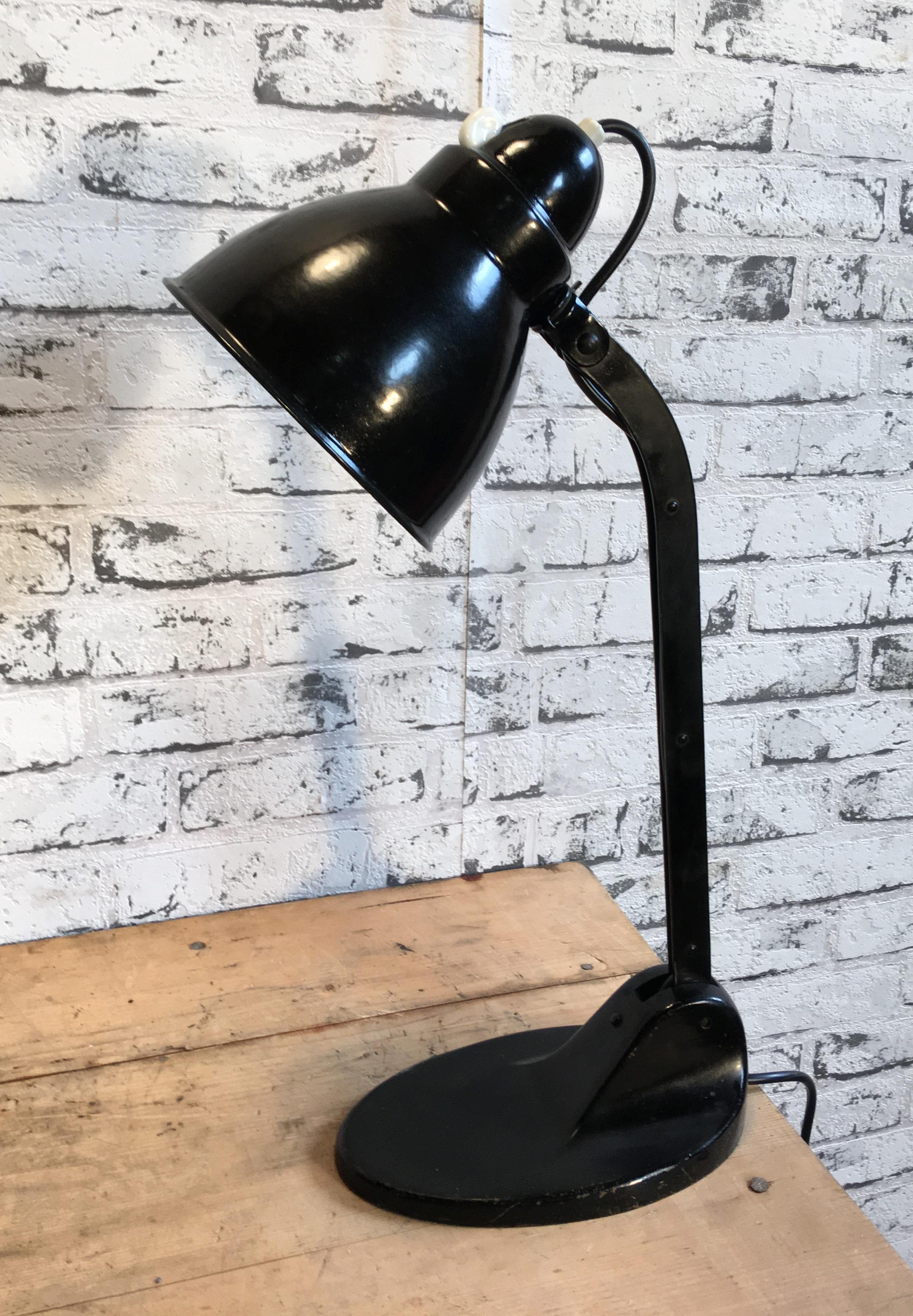 This Bauhaus industrial desk lamp was made by Victoria Lampe during the 1930s.Lamp has black enamel shade ,white interior , iron base with two adjustable joints and original socket for E 27 bulbs with rotary switch. Shade diameter: 15cm.
Very good