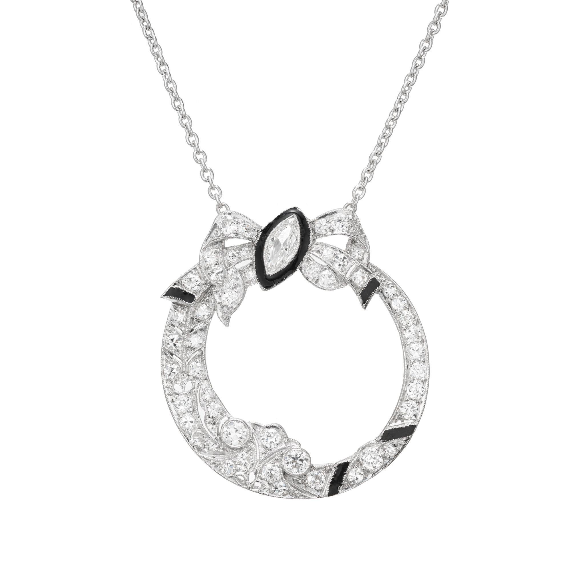 Bow style Diamond and enamel platinum and white gold pendant necklace. 1 Marquise diamond with a black enamel halo with 48 old European cut accent diamonds.  Platinum solid top with a 14k white gold back. Platinum 16 inch chain and spring ring.