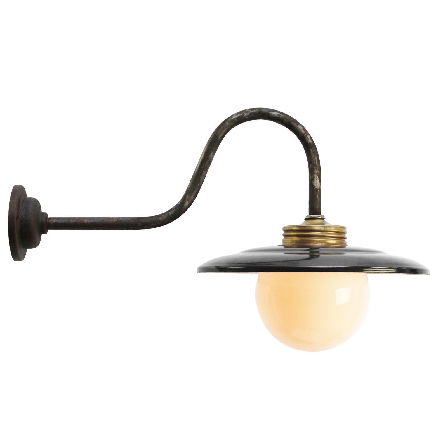 Black enamel industrial wall light with white interior.
cast iron, opaline glass globe.

diameter cast iron wall mount: 10.5 cm / 4” cm, 2 holes to secure.

Weight: 1.80 kg / 4 lb

Priced per individual item. All lamps have been made suitable by