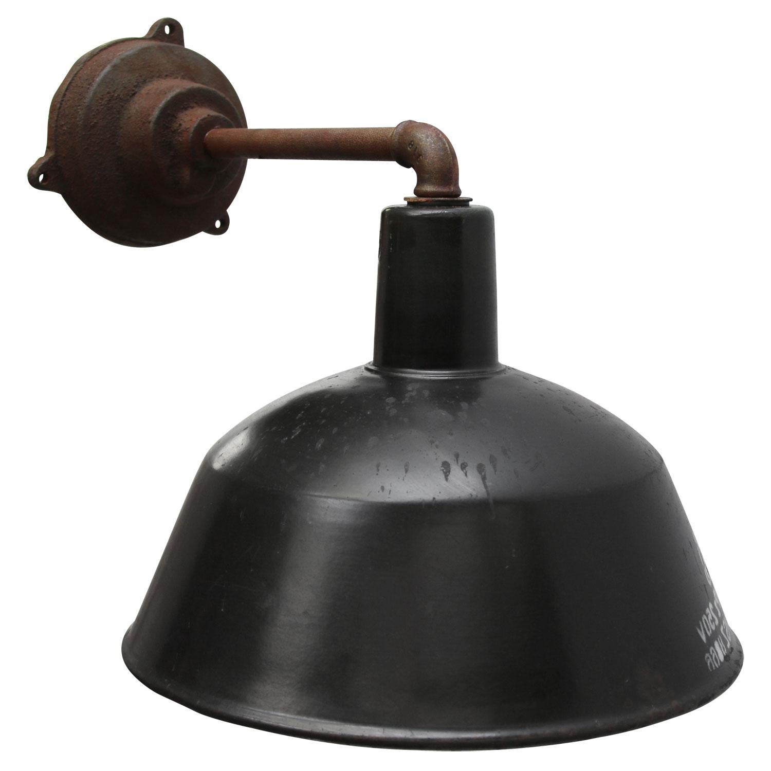 Factory wall light. Black enamel. White interior.
Diameter cast iron wall piece: 12 cm, three holes to secure. 

Weight: 3.10 kg / 6.8 lb

Priced per individual item. All lamps have been made suitable by international standards for incandescent