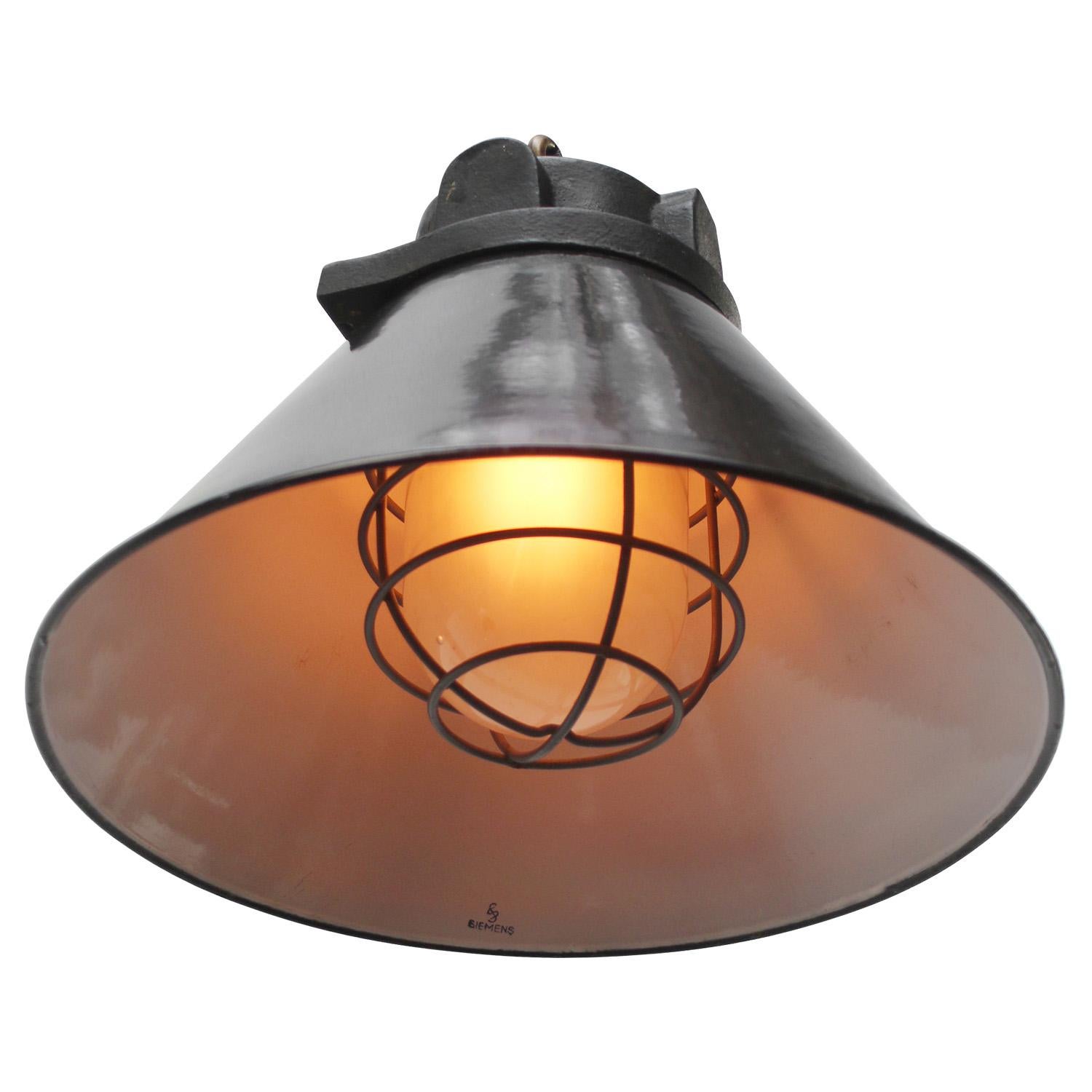 Original Siemens factory pendant
very rare early model
black enamel white interior
cast iron top with frosted glass and cage

Weight: 6.20 kg / 13.7 lb

Priced per individual item. All lamps have been made suitable by international standards for