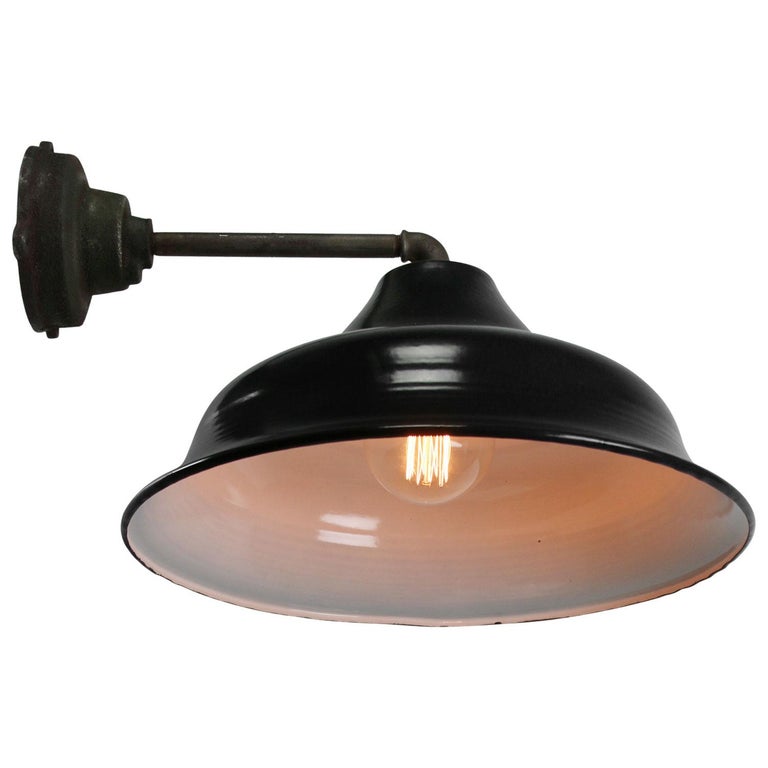 Factory wall light. Black enamel. White interior. 

Diameter cast iron wall piece: 12 cm, three holes to secure.

Weight: 3.40 kg / 7.5 lb

Priced per individual item. All lamps have been made suitable by international standards for